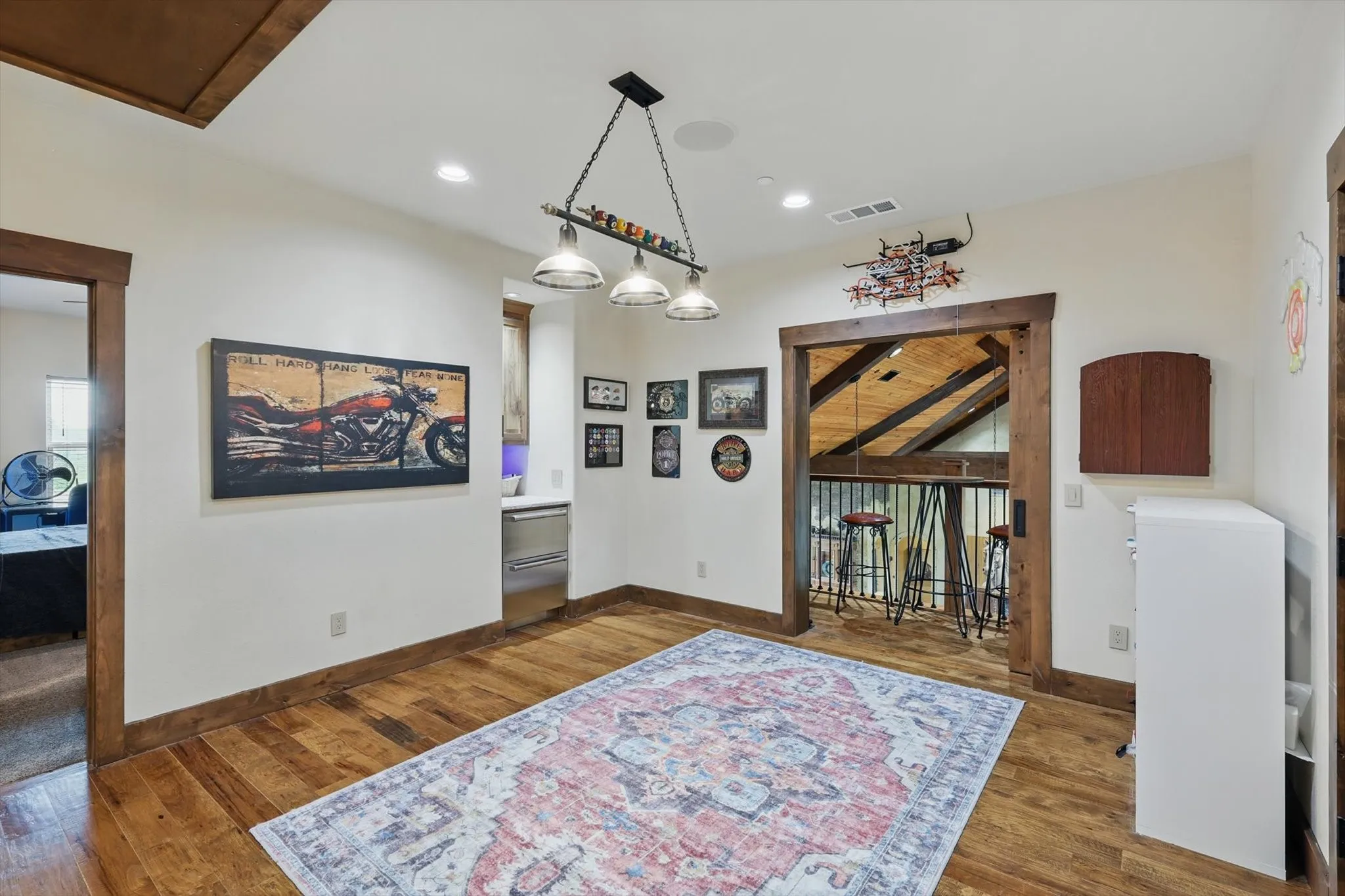 Dining space with dark wood-style flooring and recessed lighting