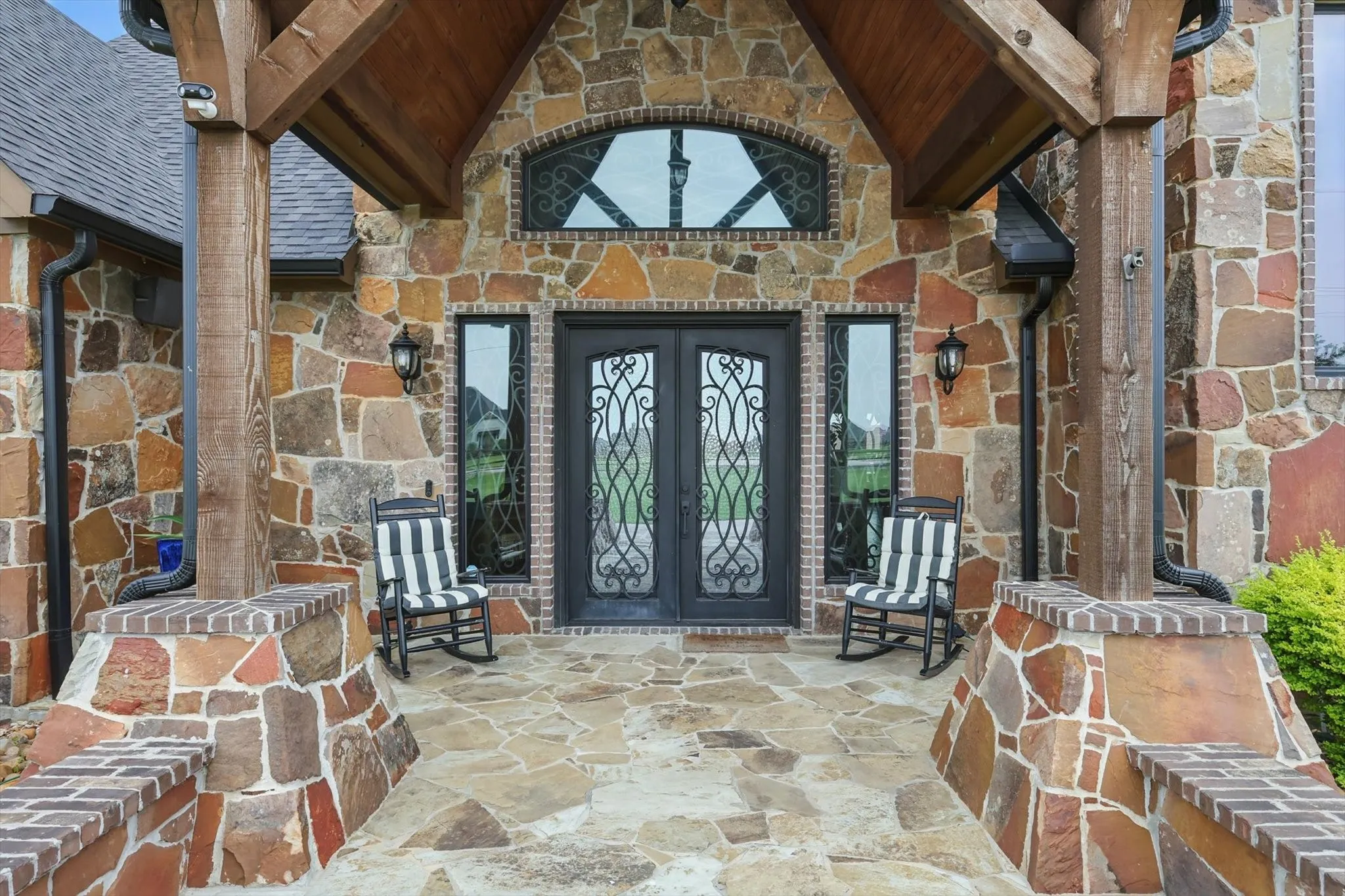 Doorway to property with stone siding and french doors