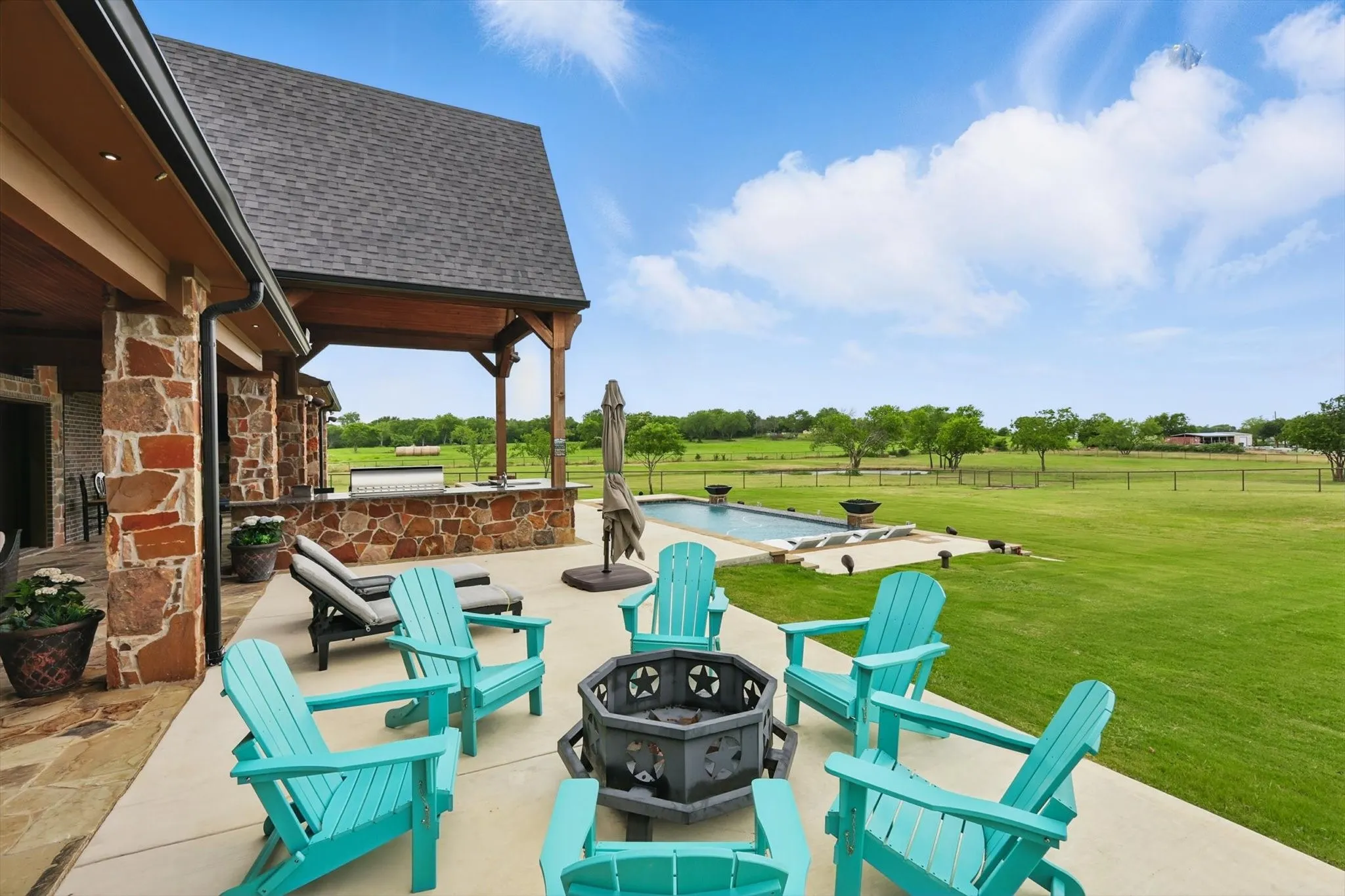 View of patio / terrace with an outdoor pool and a fire pit
