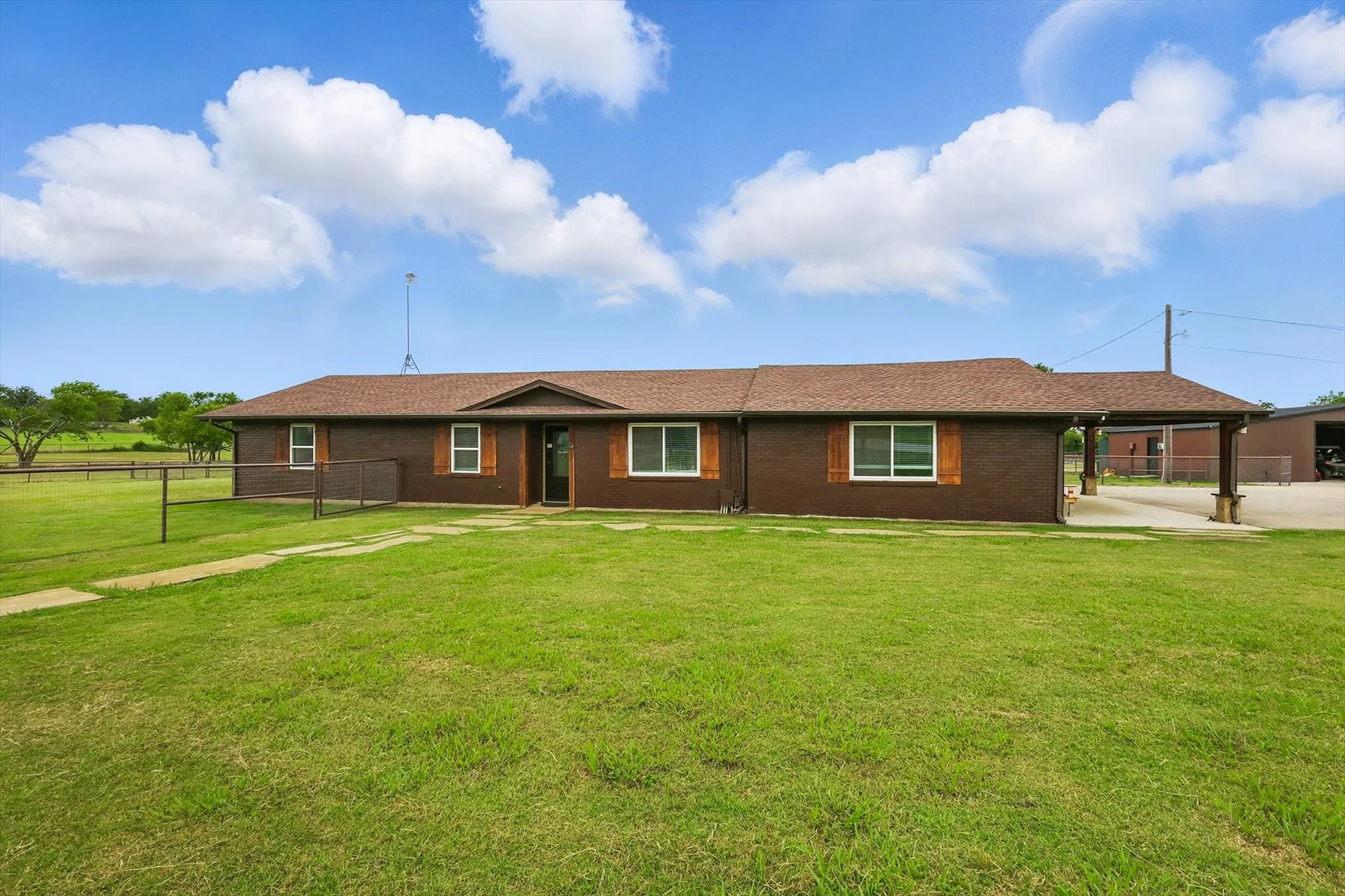 Ranch-style home featuring brick siding and a shingled roof