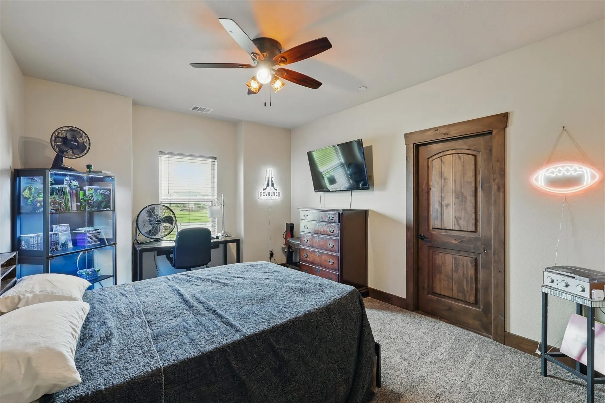 Bedroom with a ceiling fan and light colored carpet