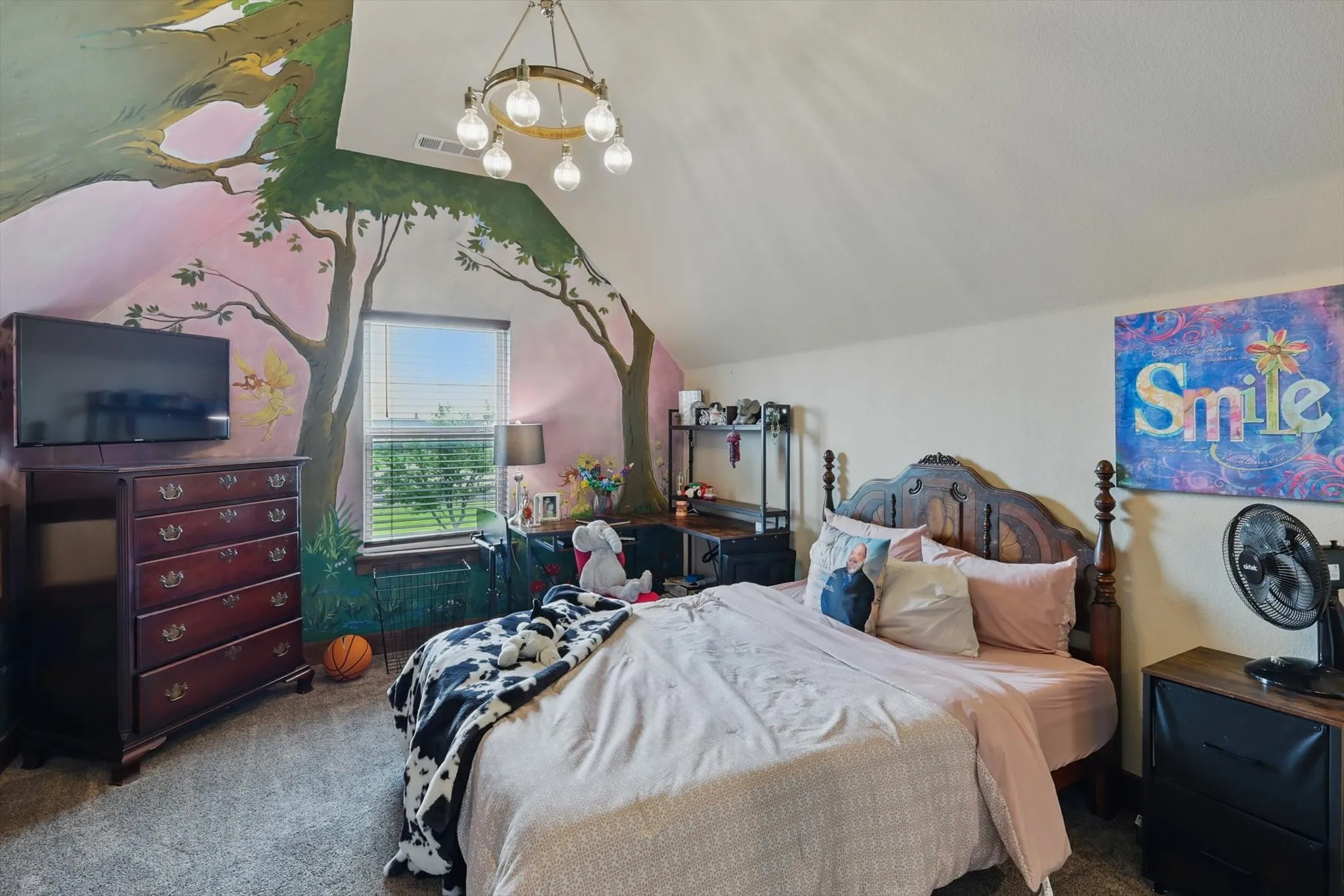Carpeted bedroom with a chandelier