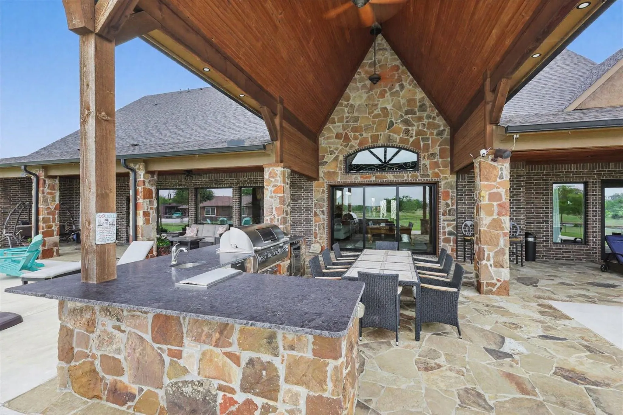 View of patio / terrace with an outdoor kitchen and a sink