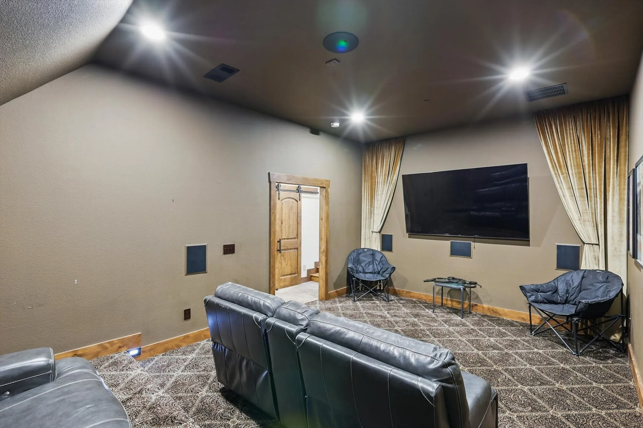 Cinema room with baseboards and lofted ceiling