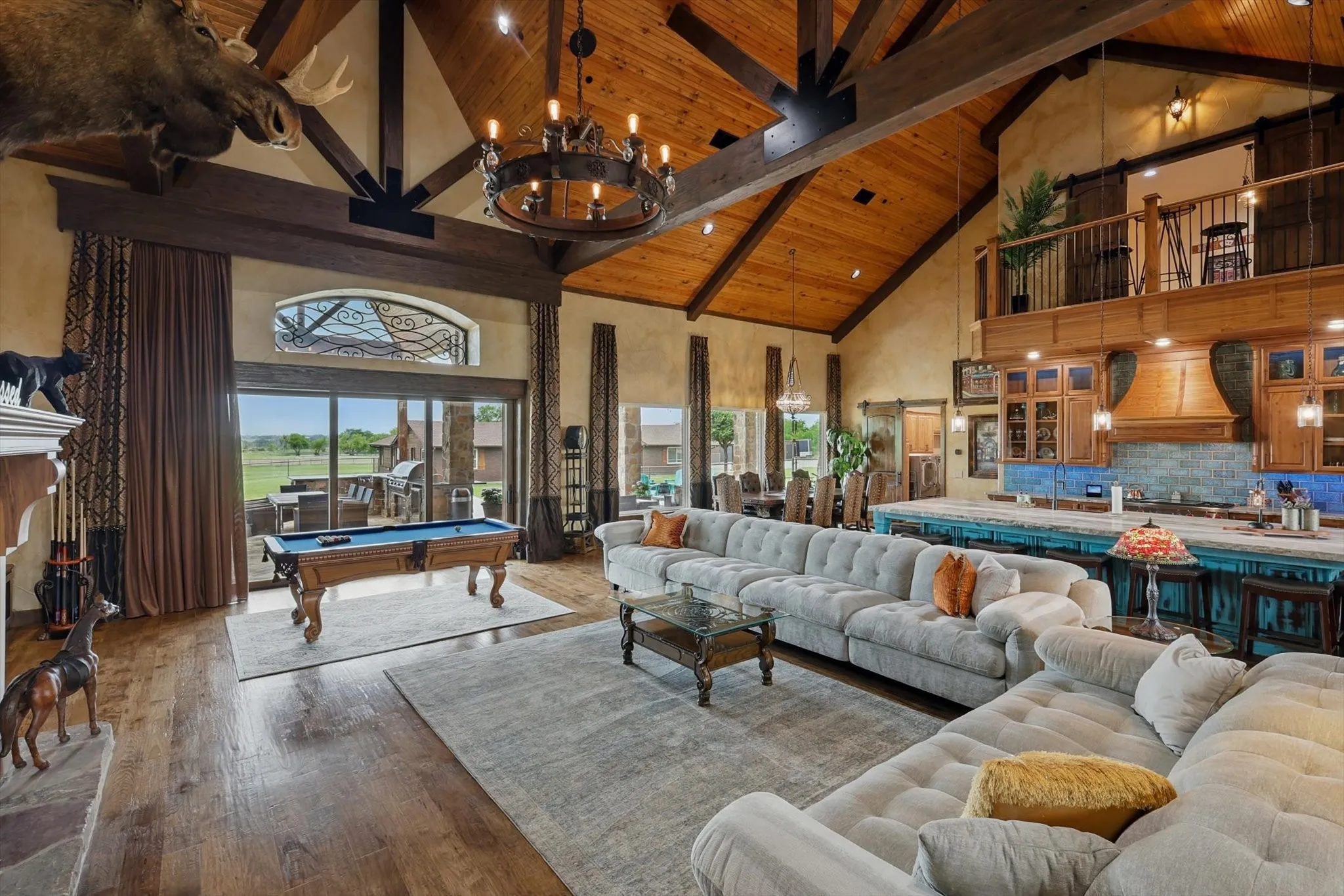 Living area featuring pool table, a high wood beamed ceiling, and dark wood-style flooring