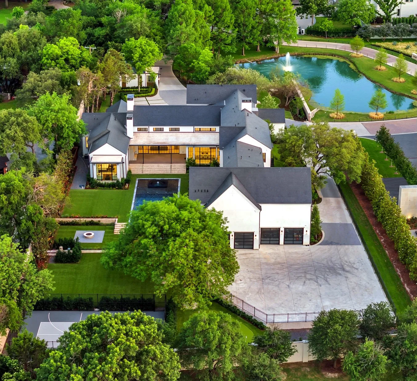 Aerial view of backyard, 4-car garage, and large motor court