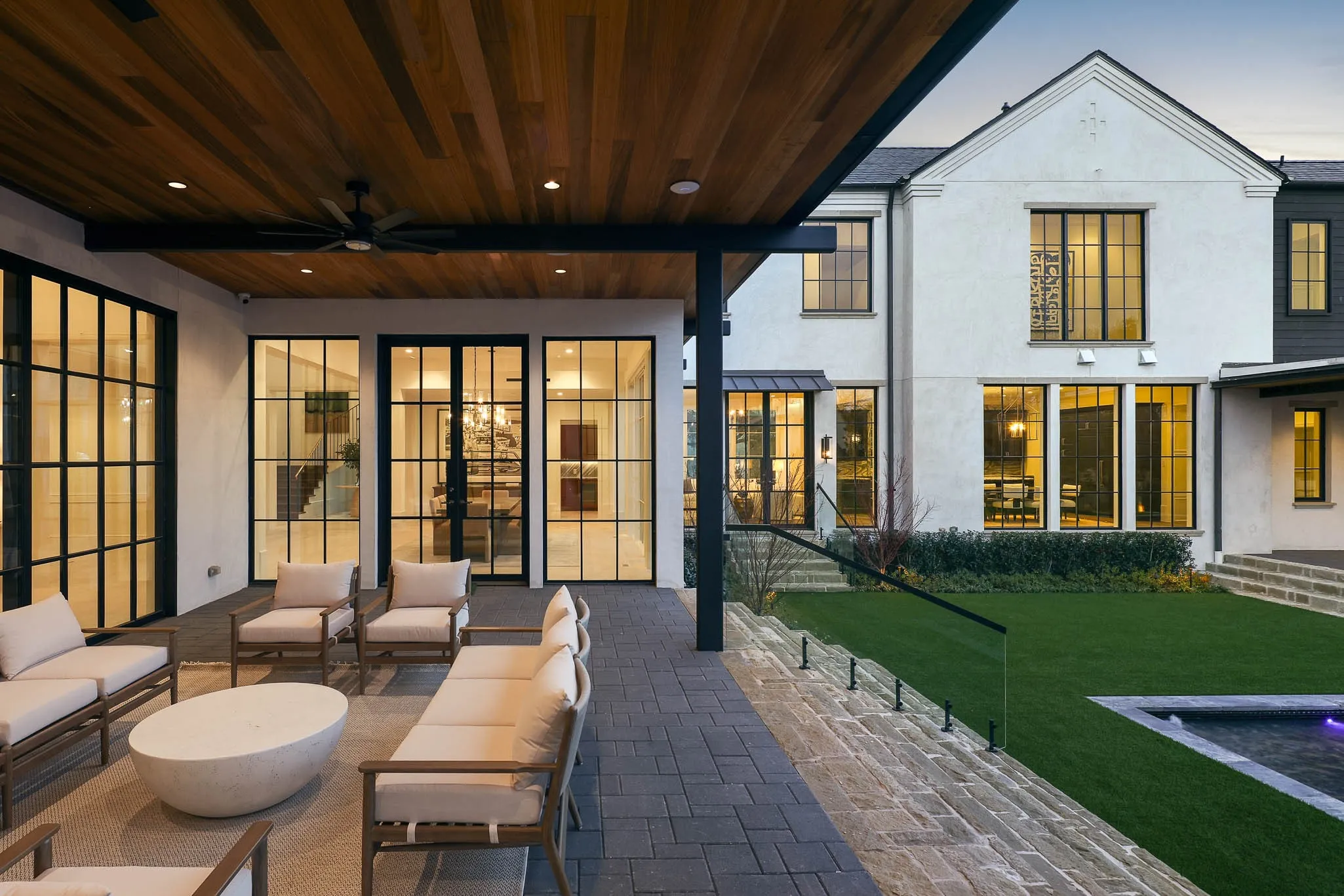 Outdoor covered loggia overlooking turfed yard