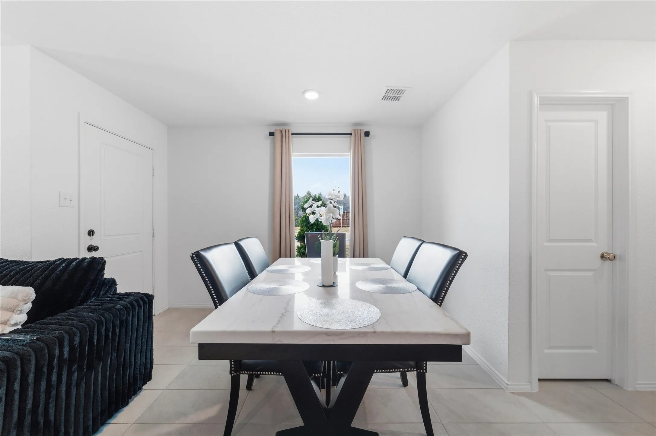 Dining area featuring baseboards and light tile patterned floors