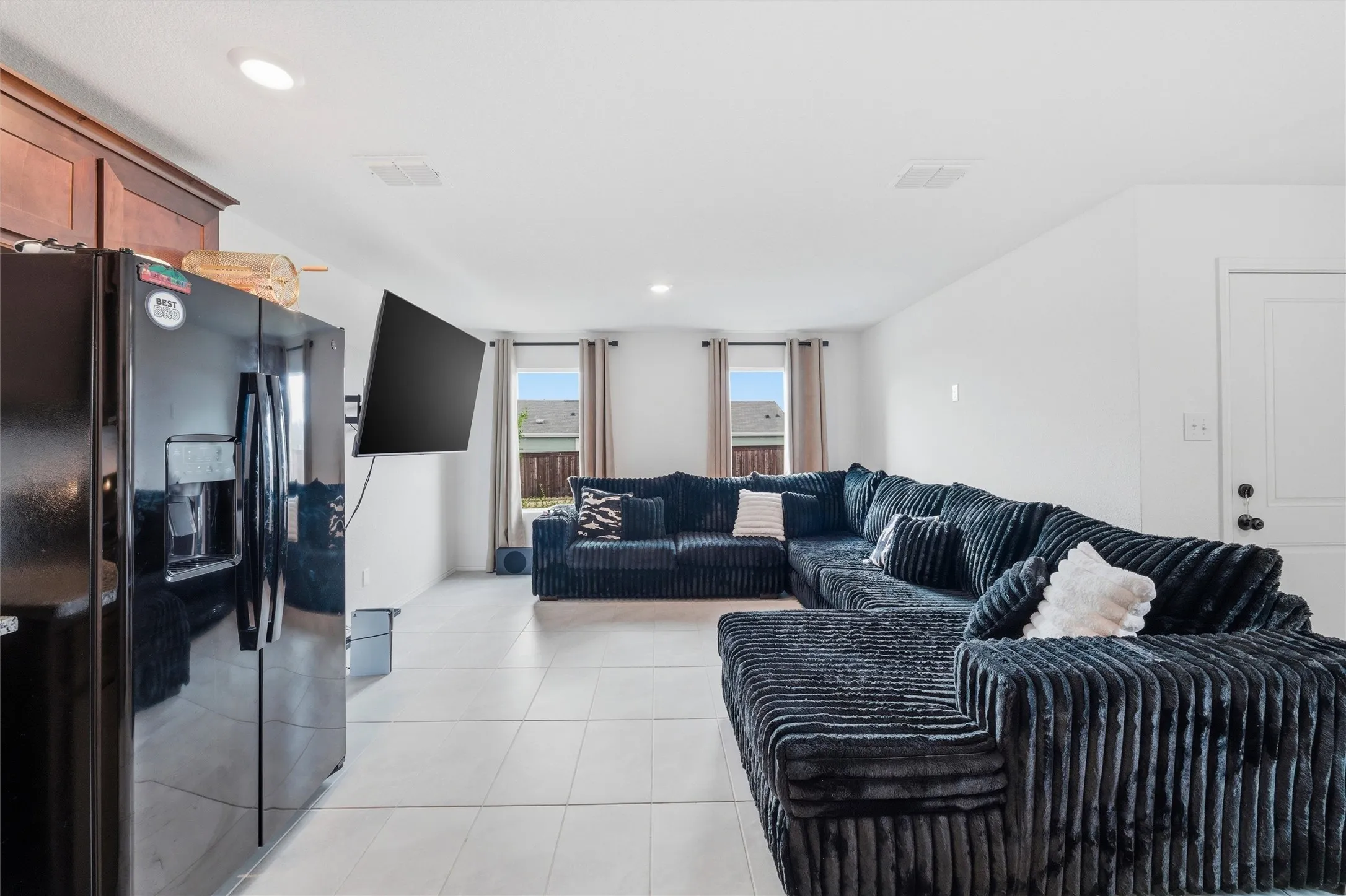 Living area featuring light tile patterned floors and recessed lighting