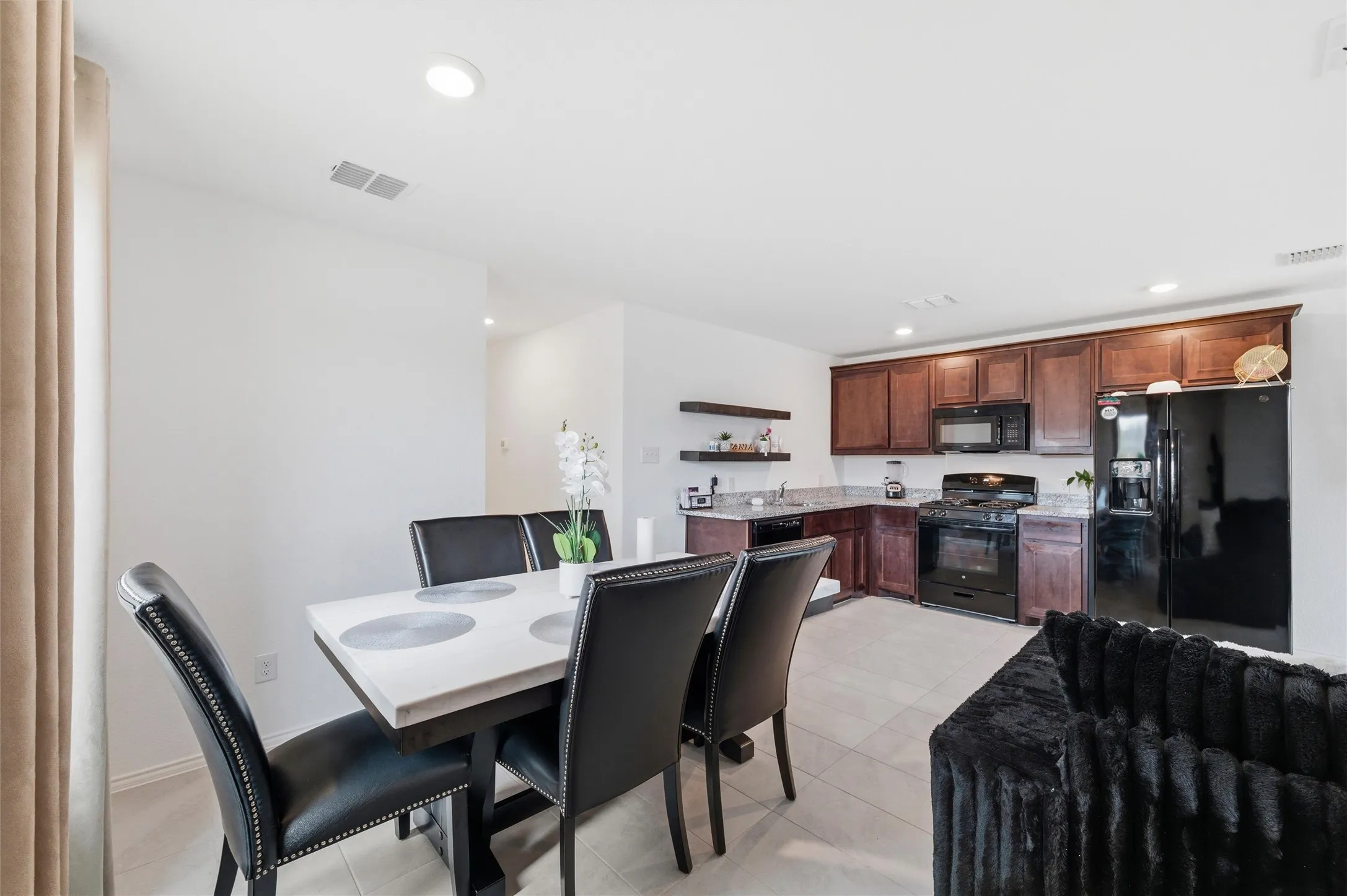 Dining area featuring recessed lighting and light tile patterned floors