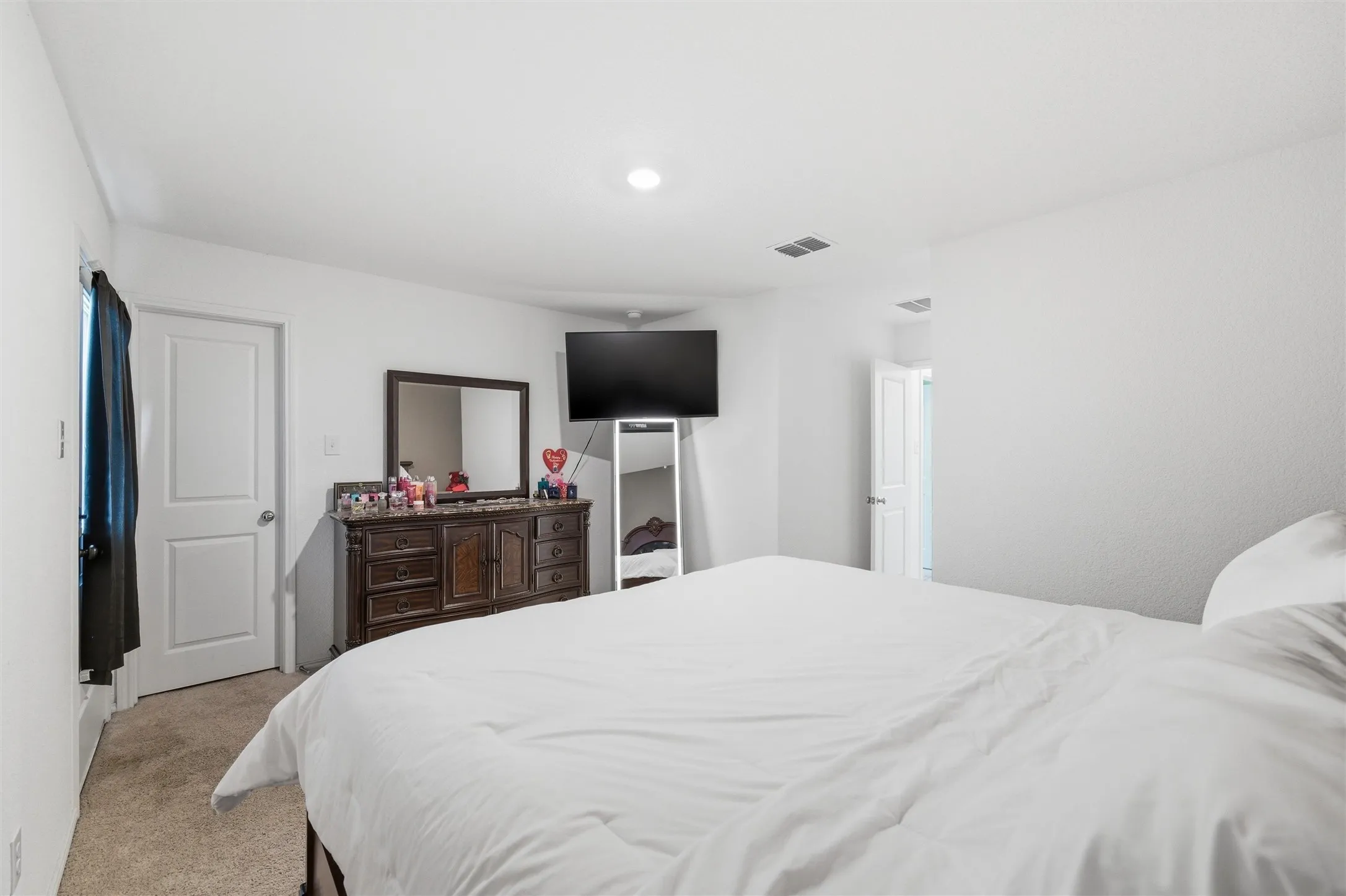 Bedroom with light colored carpet