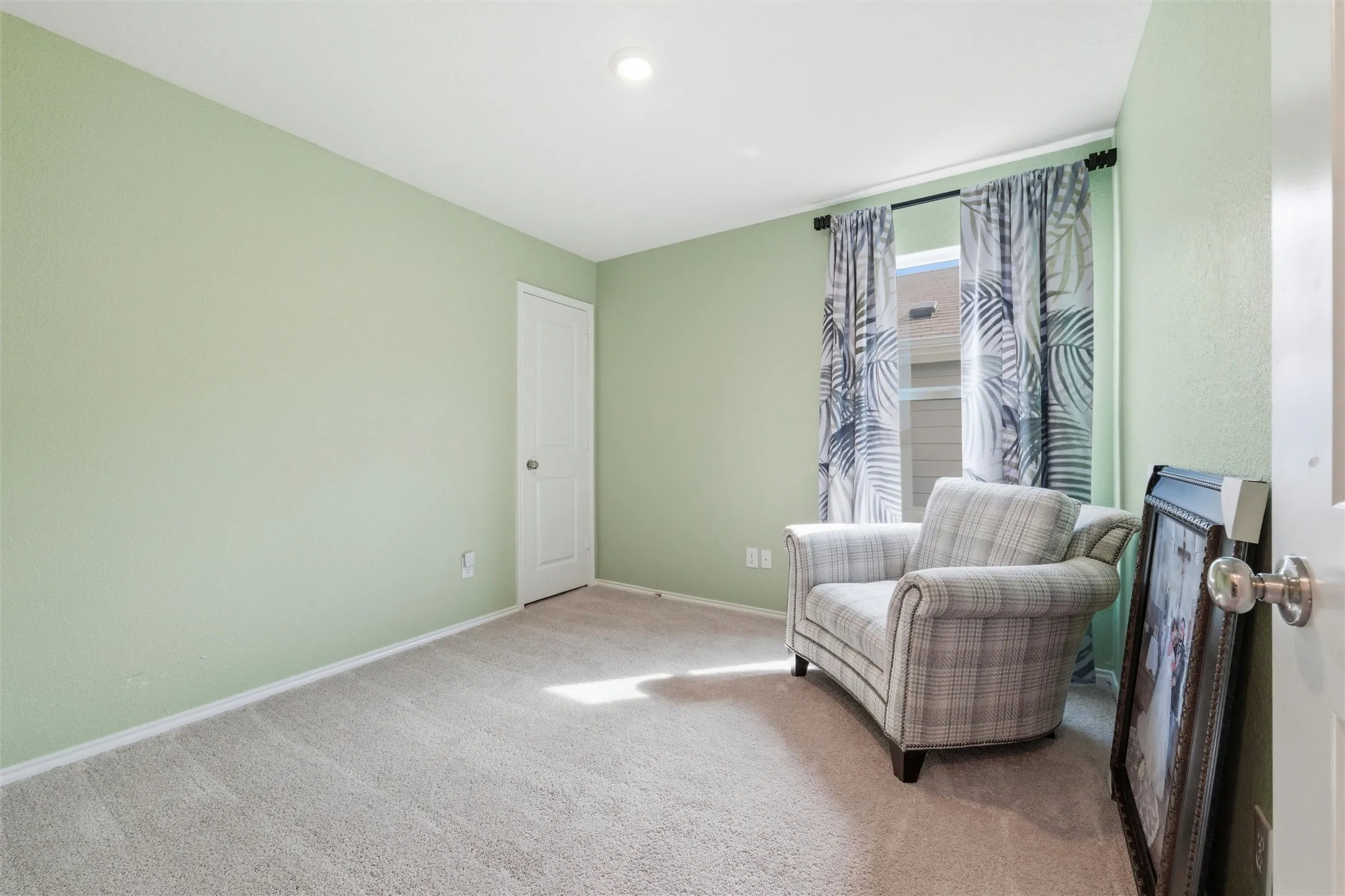 Living area with baseboards and carpet