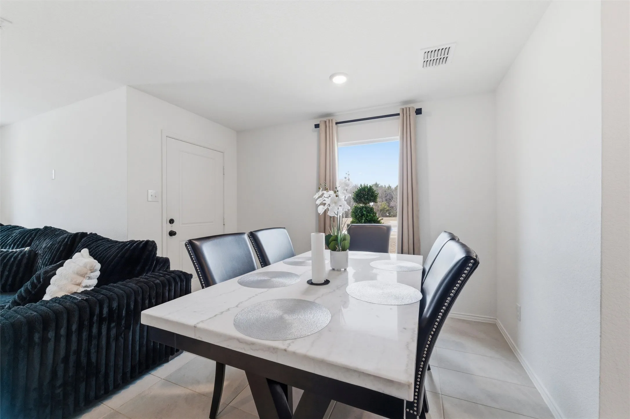 Dining space featuring baseboards and light tile patterned floors