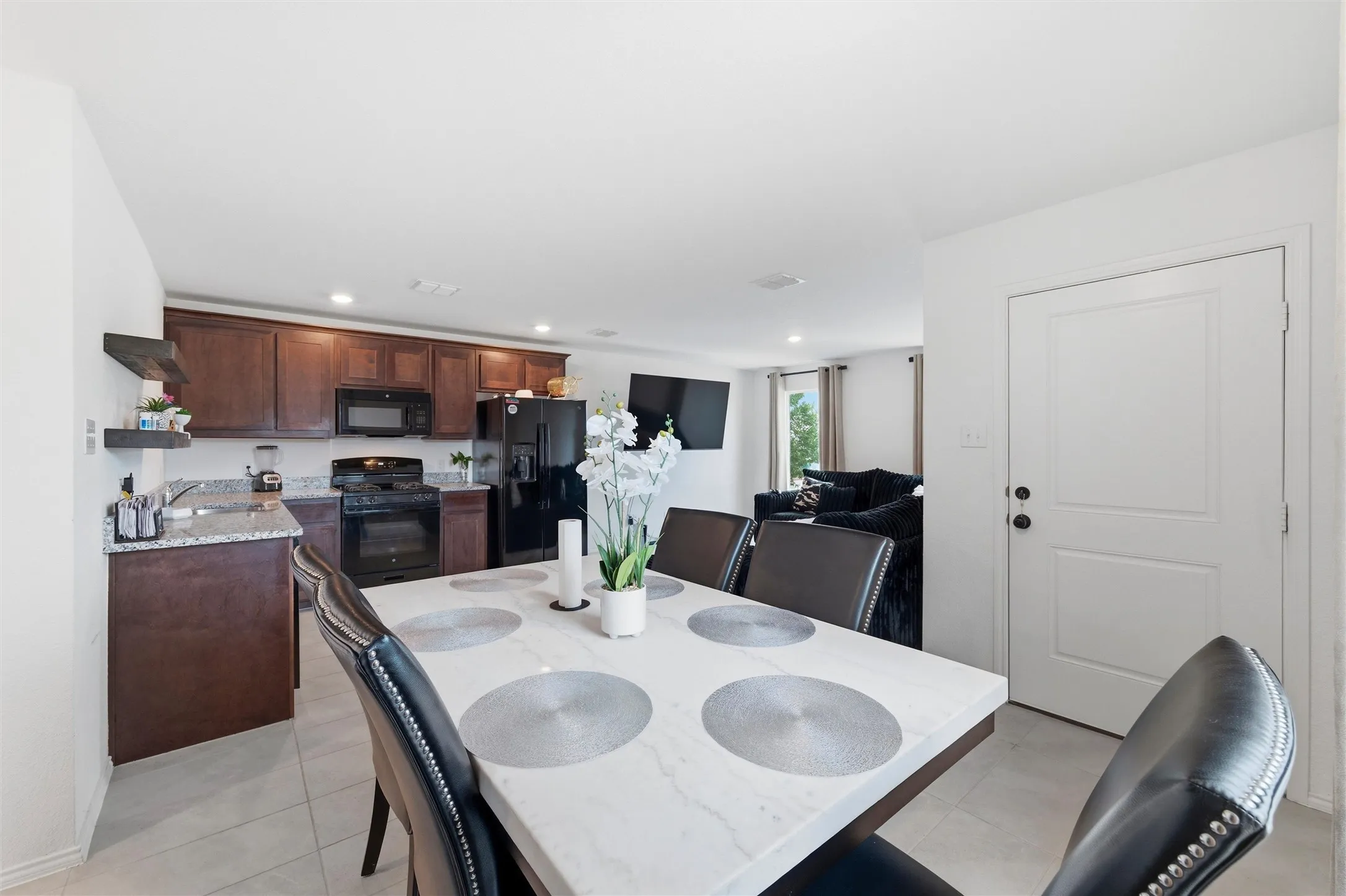 Dining space featuring recessed lighting and light tile patterned floors