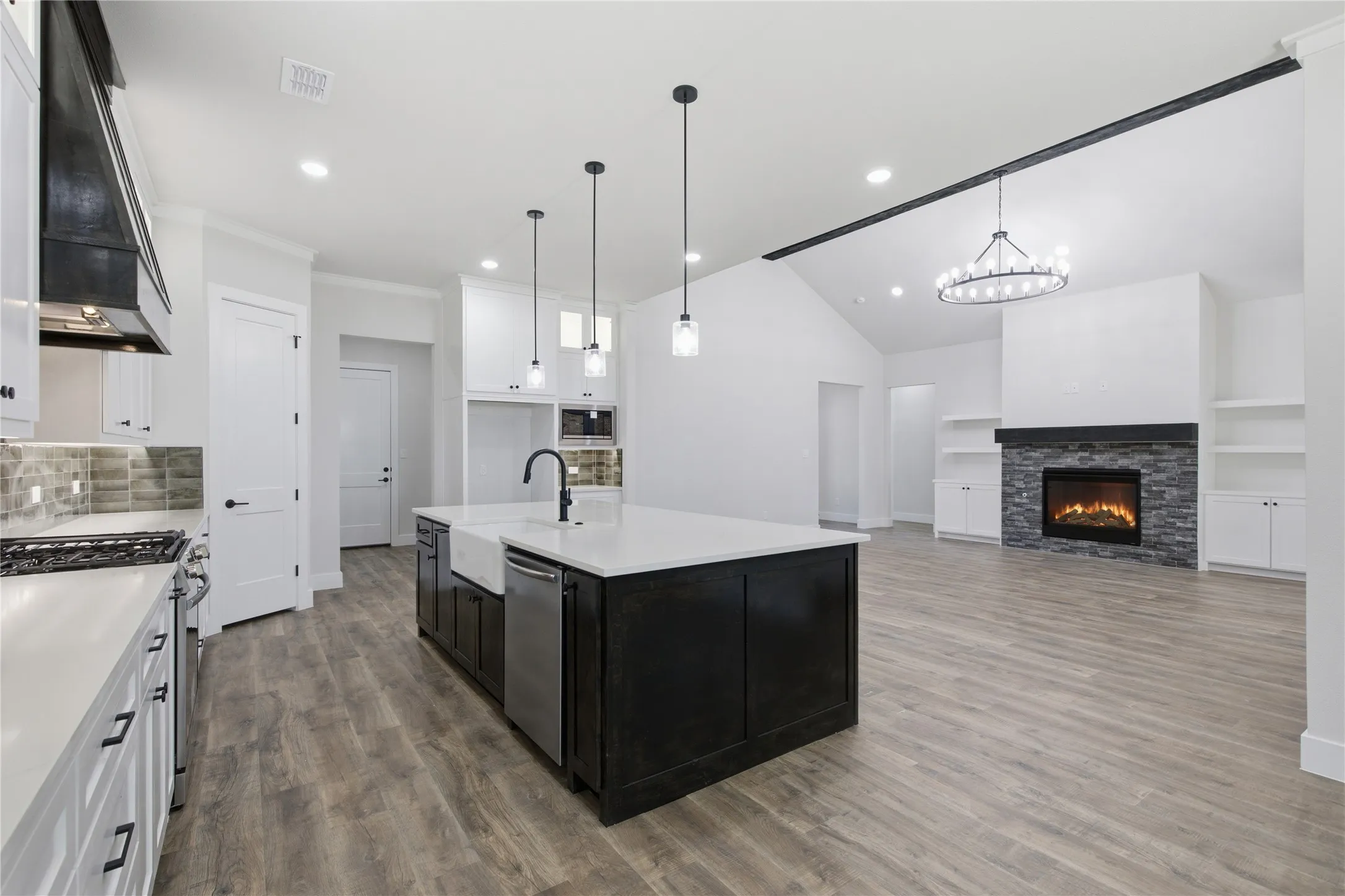 Gourmet kitchen with an expansive island, farmhouse sink, and stainless steel appliances