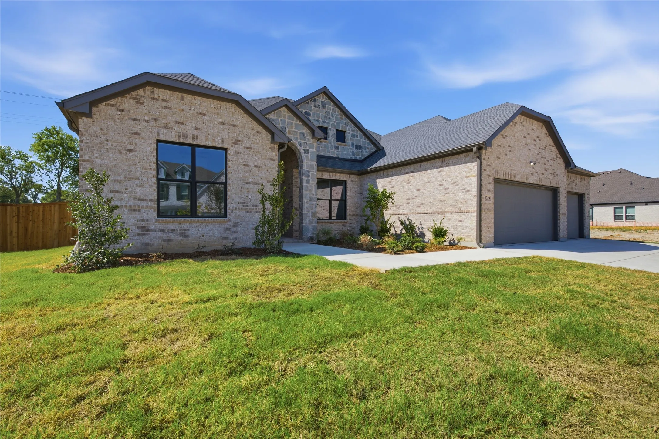 Brick exterior with stone accents and dark-framed windows