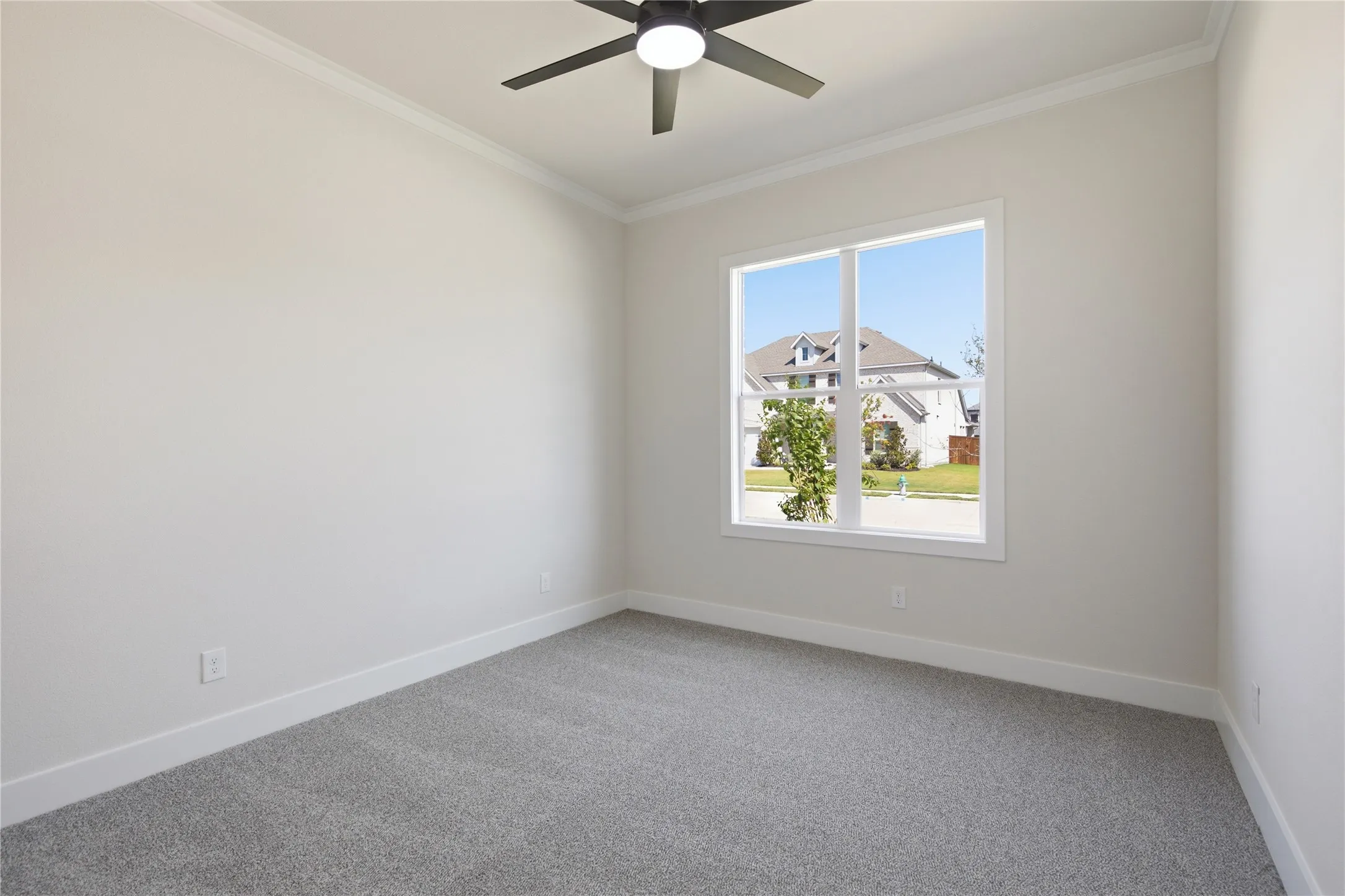 Recessed window with white trim, gray carpet, white walls, and a ceiling fan