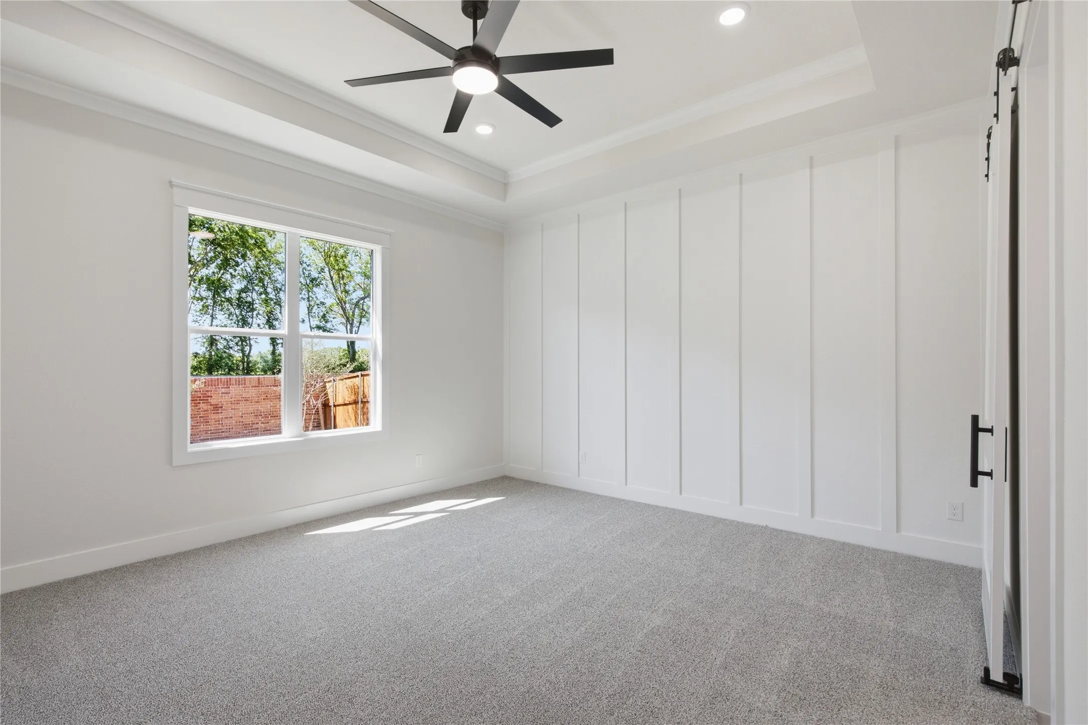 Tray ceiling with recessed lighting and a ceiling fan