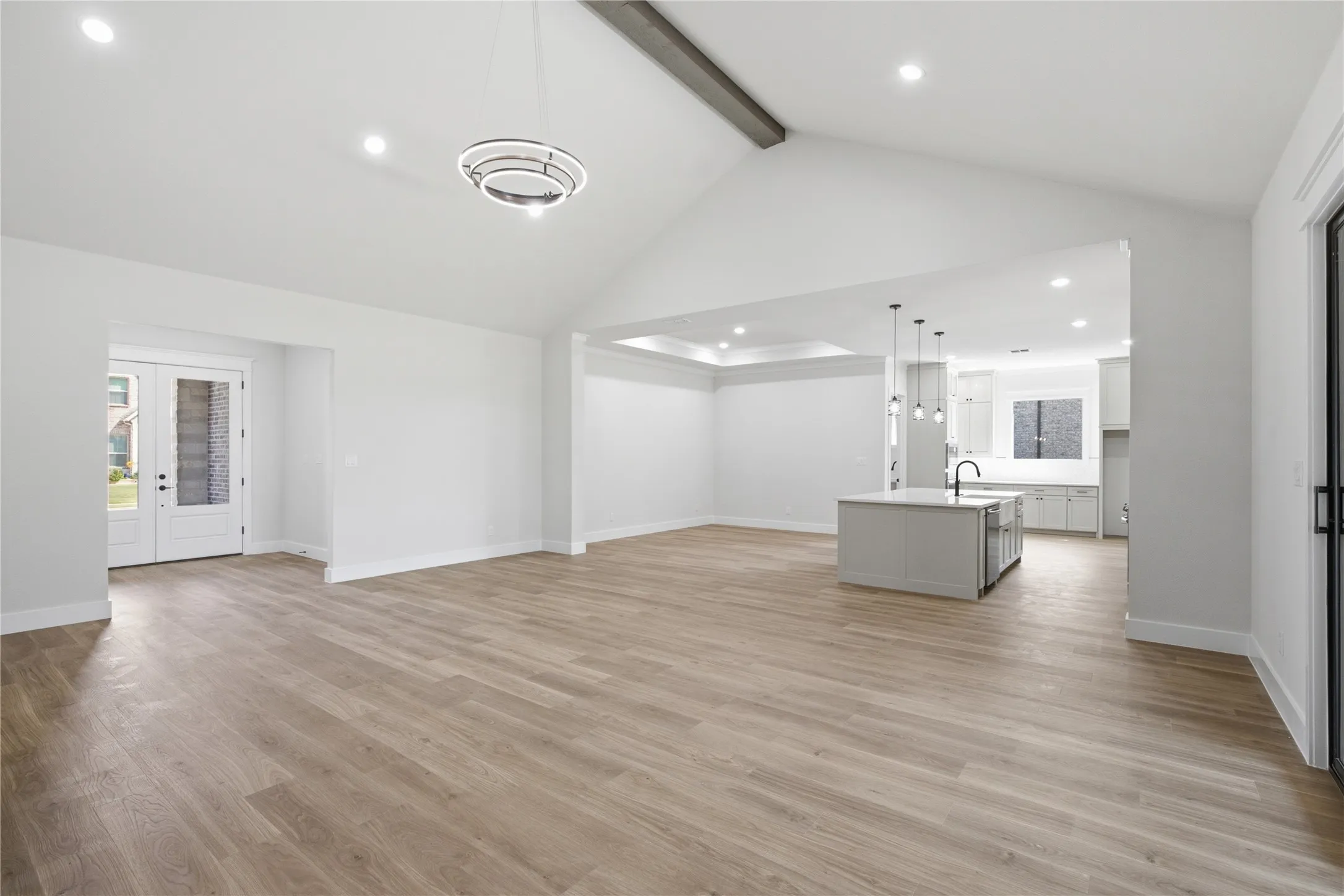 Vaulted ceiling with exposed beam and recessed lighting