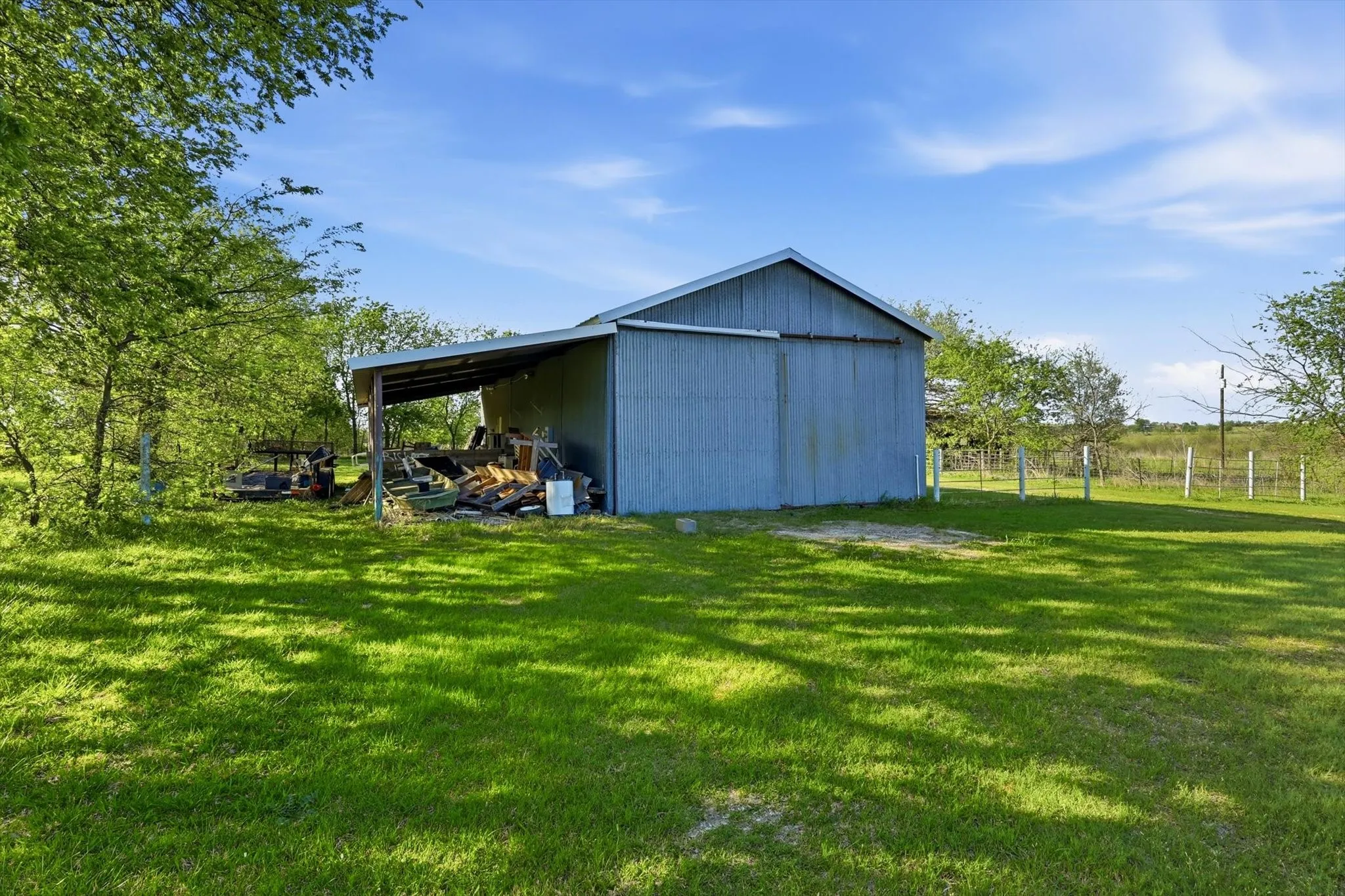 View of pole building featuring a yard