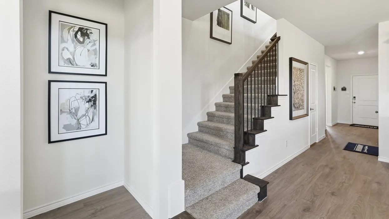 Stairway featuring baseboards and wood finished floors
