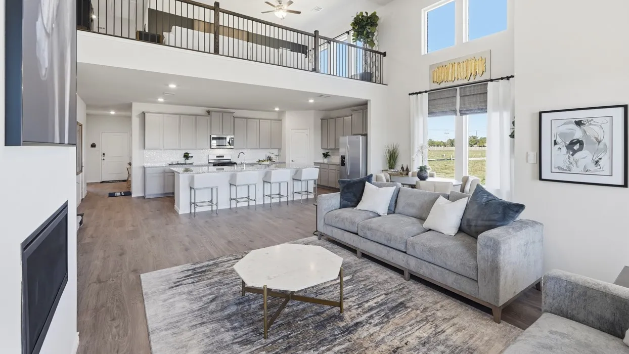 Living room featuring ceiling fan, wood finished floors, recessed lighting, and a high ceiling