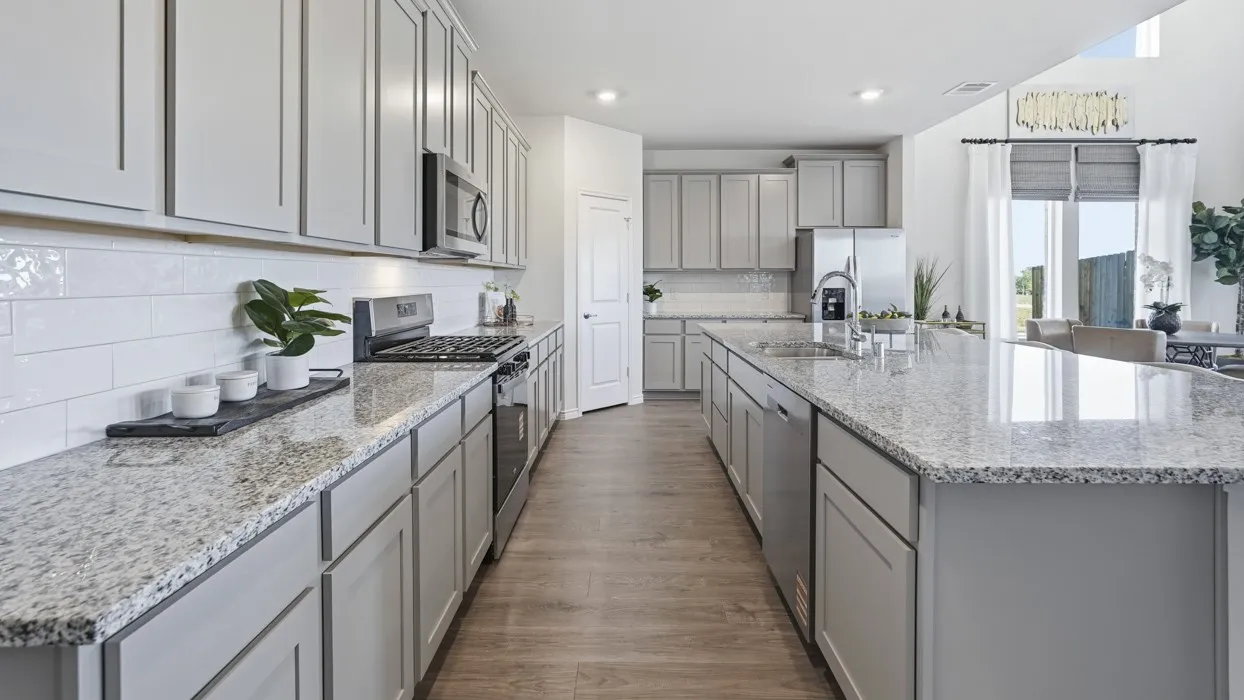 Kitchen featuring gray cabinetry, stainless steel appliances, a large island, light stone counters, and recessed lighting