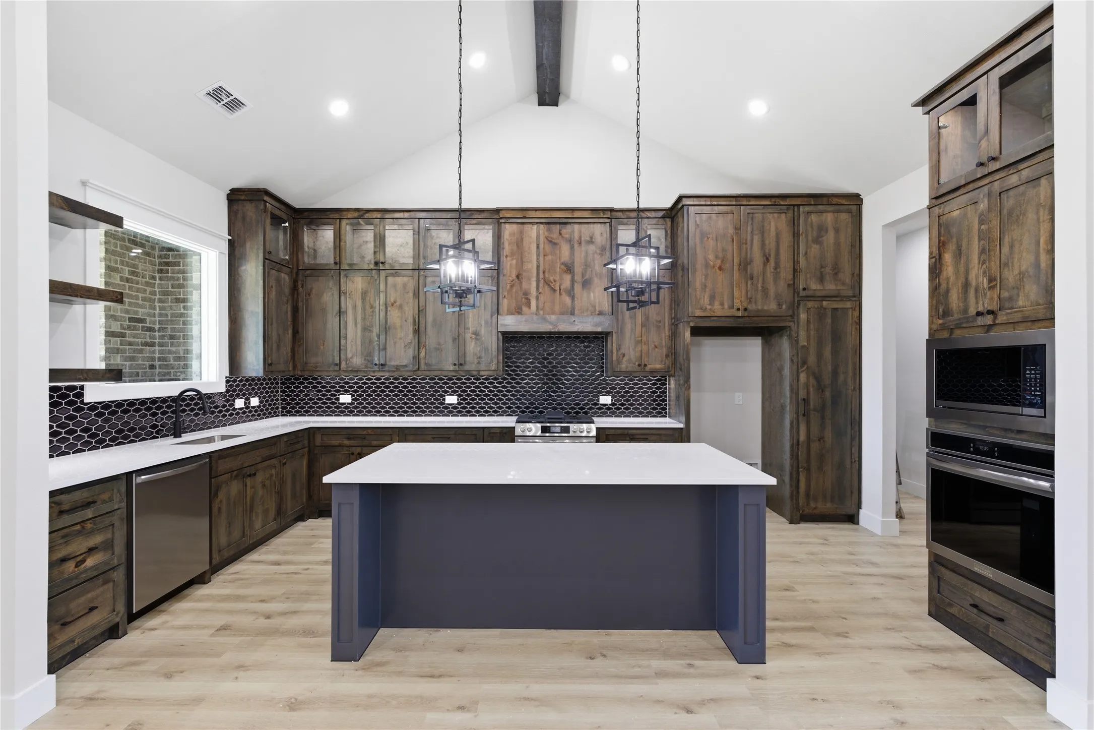 Modern kitchen featuring wood-finish cabinetry and a dark tile backsplash