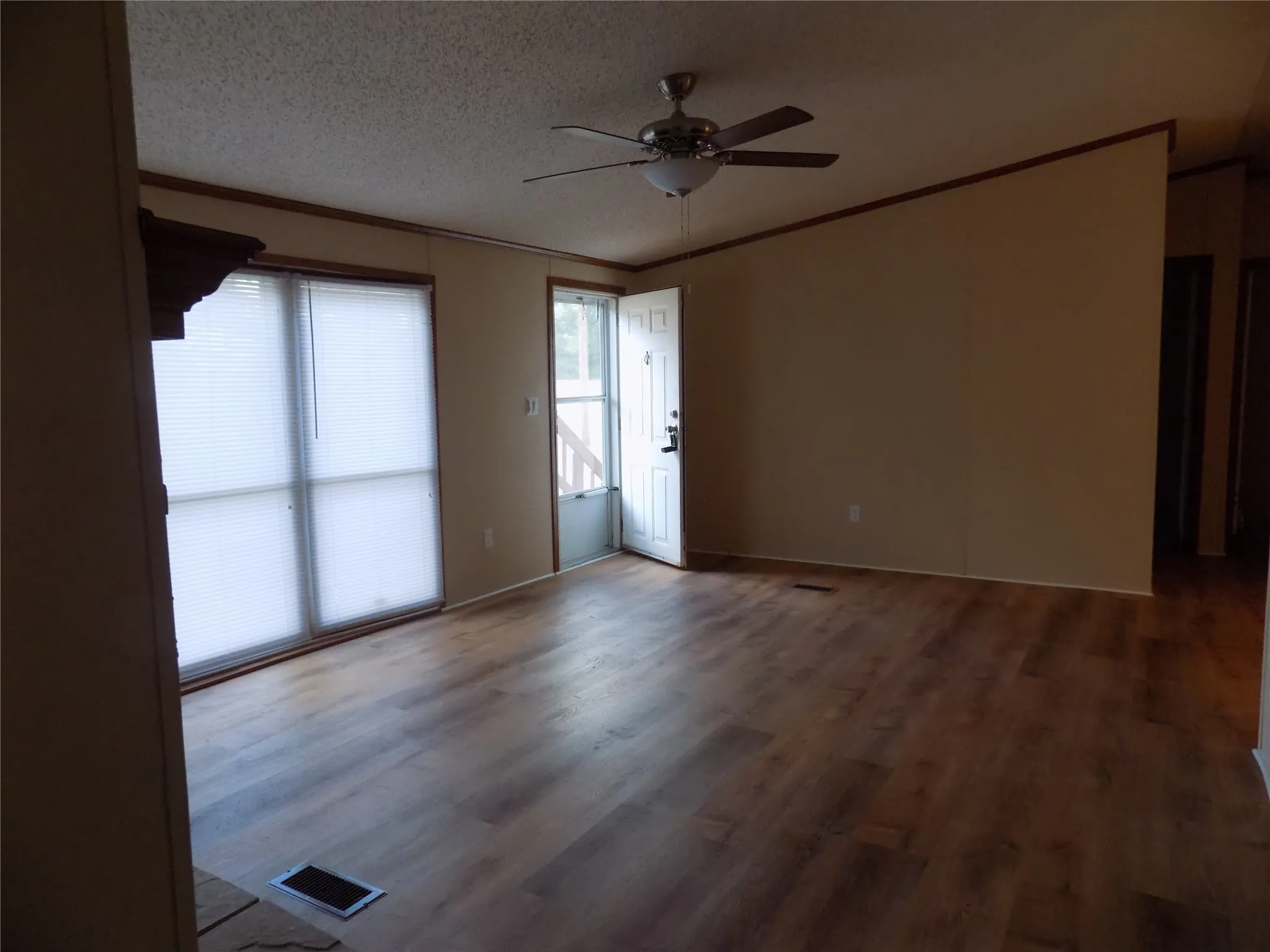 Open living room from the front door into the light and bright room.