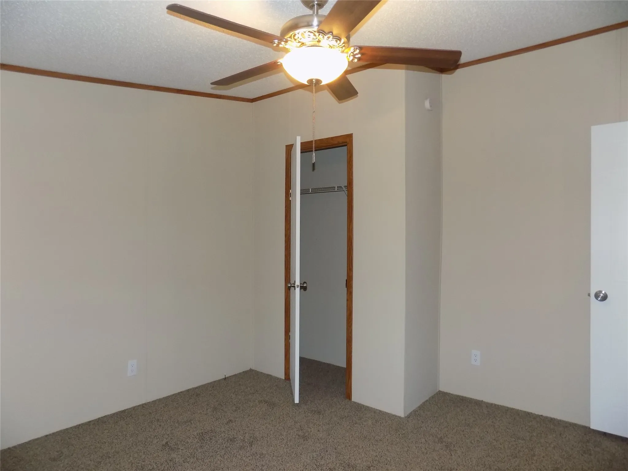 Carpeted secondary bedroom.