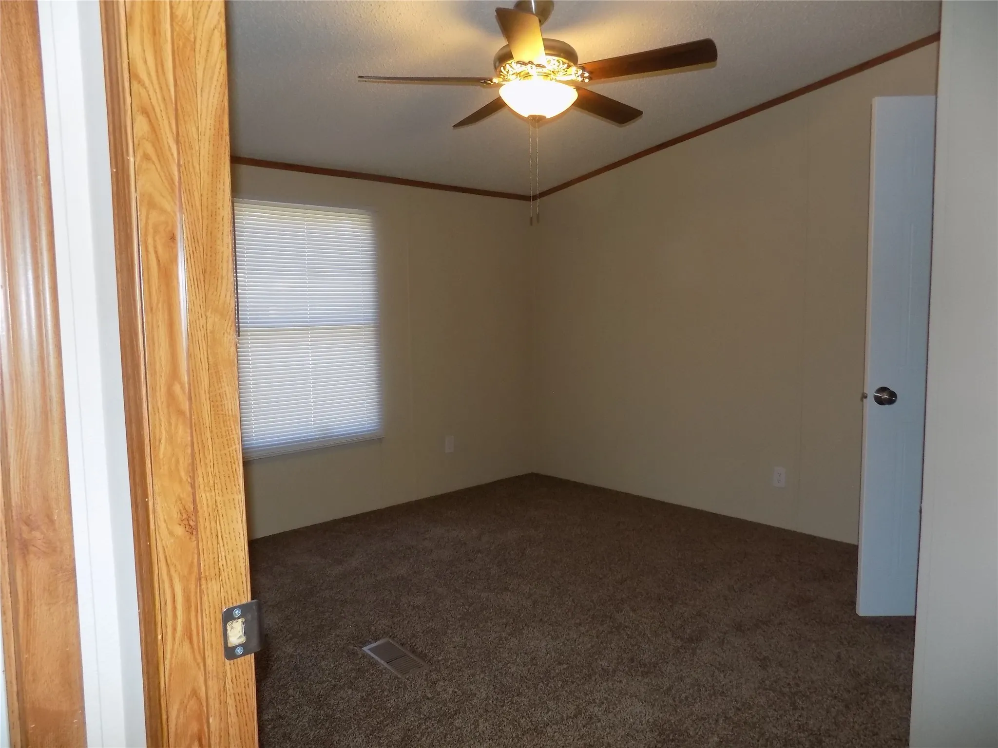 Carpeted secondary bedroom.