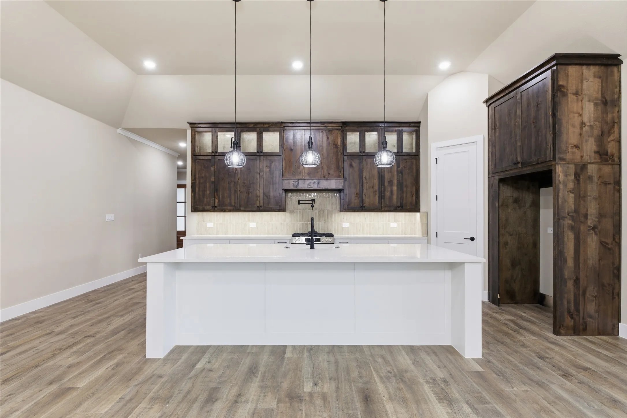 Kitchen featuring an expansive center island with a white countertop