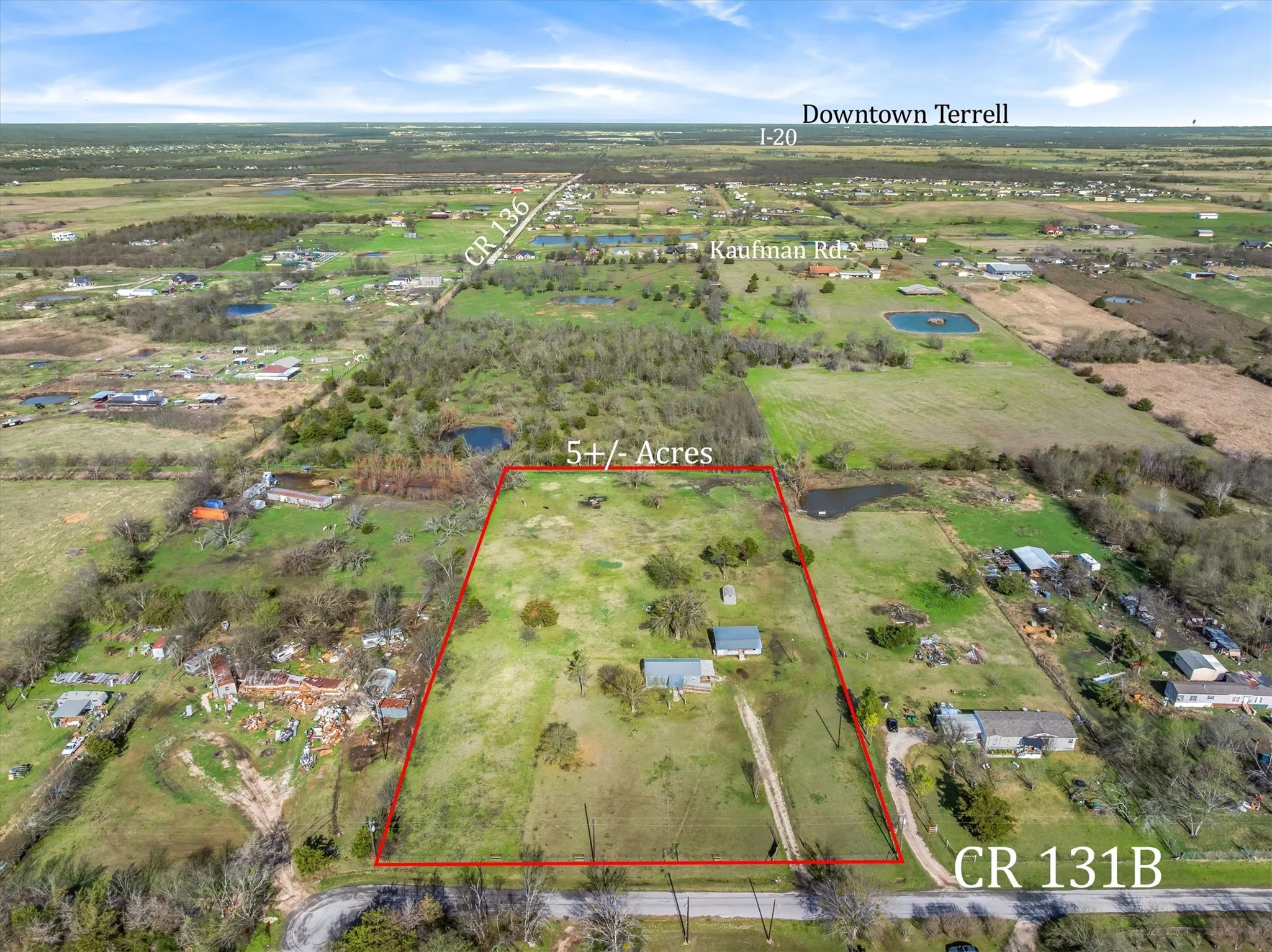 Overview of rural landscape featuring property parcel outlined and a large body of water