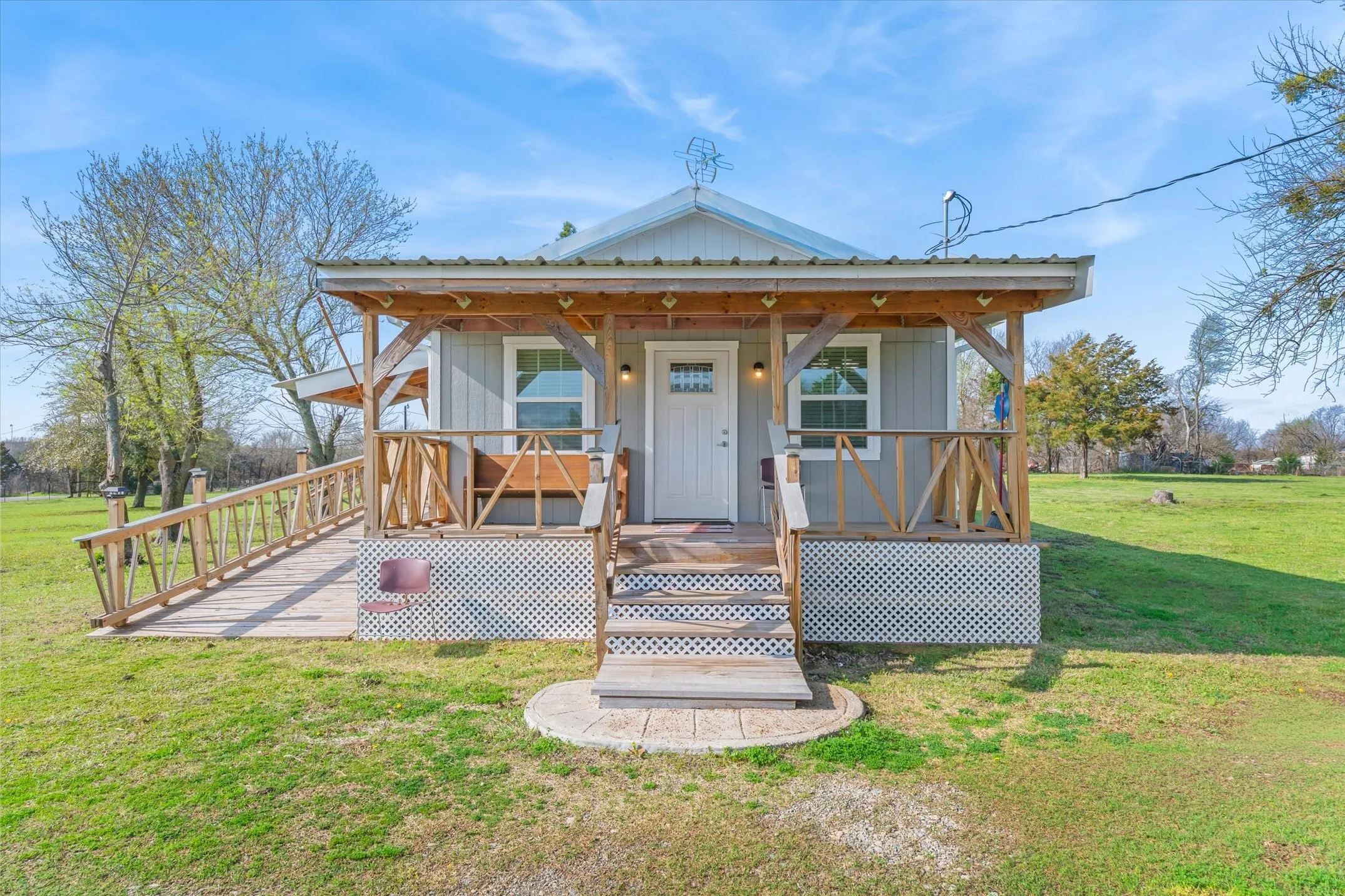 View of front of house with a front yard and covered porch