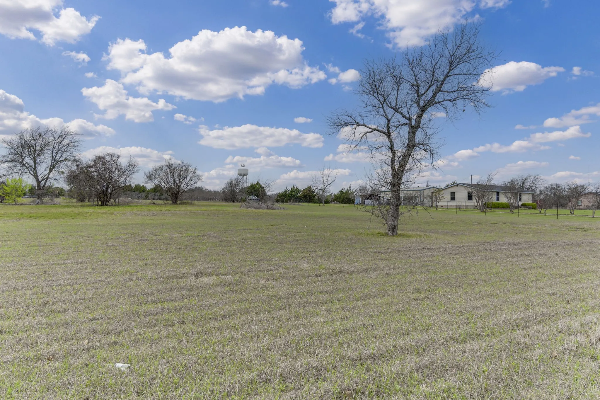 View of grassy yard with a rural view