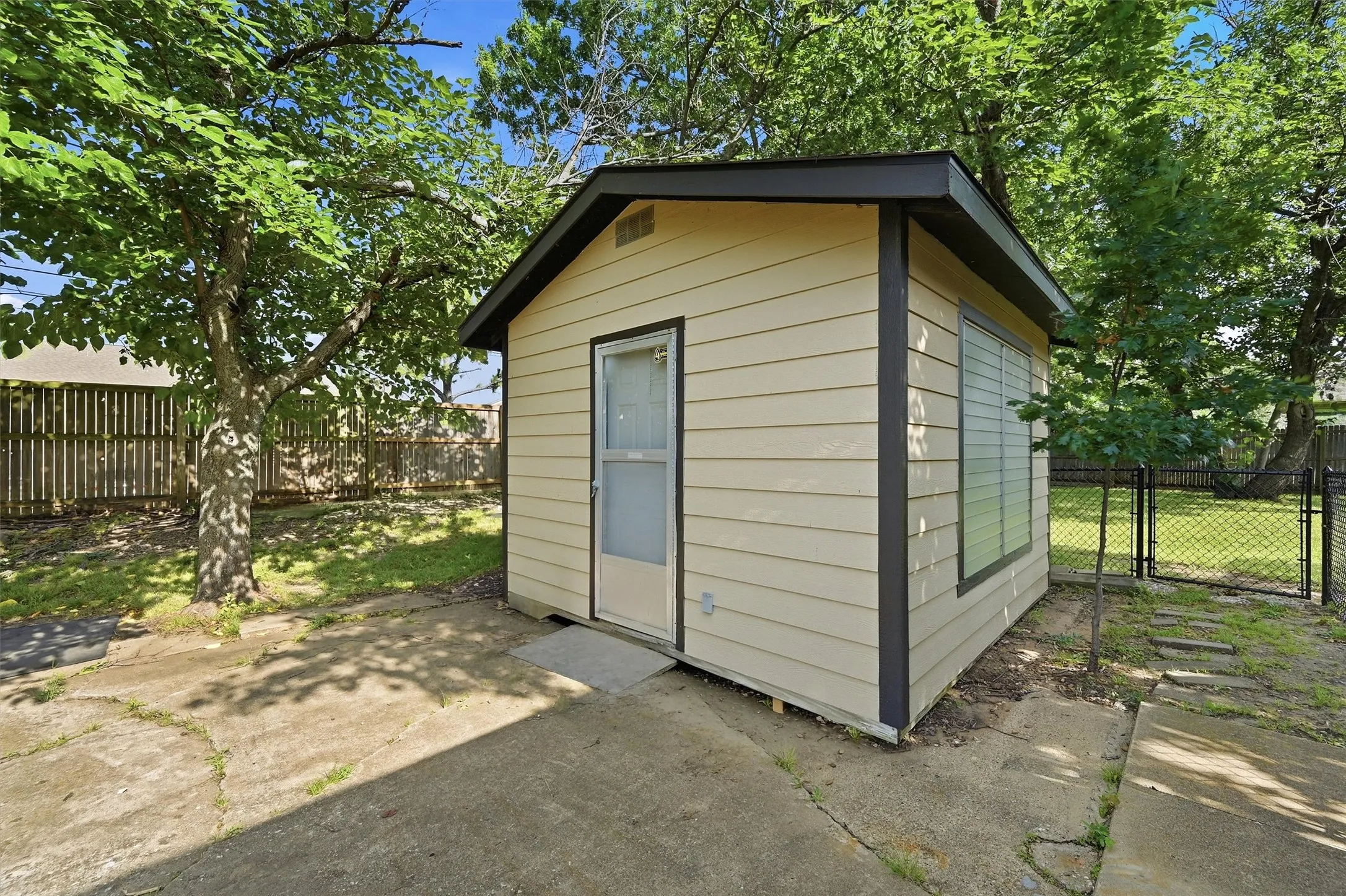 Detached shed featuring neutral siding and a side window