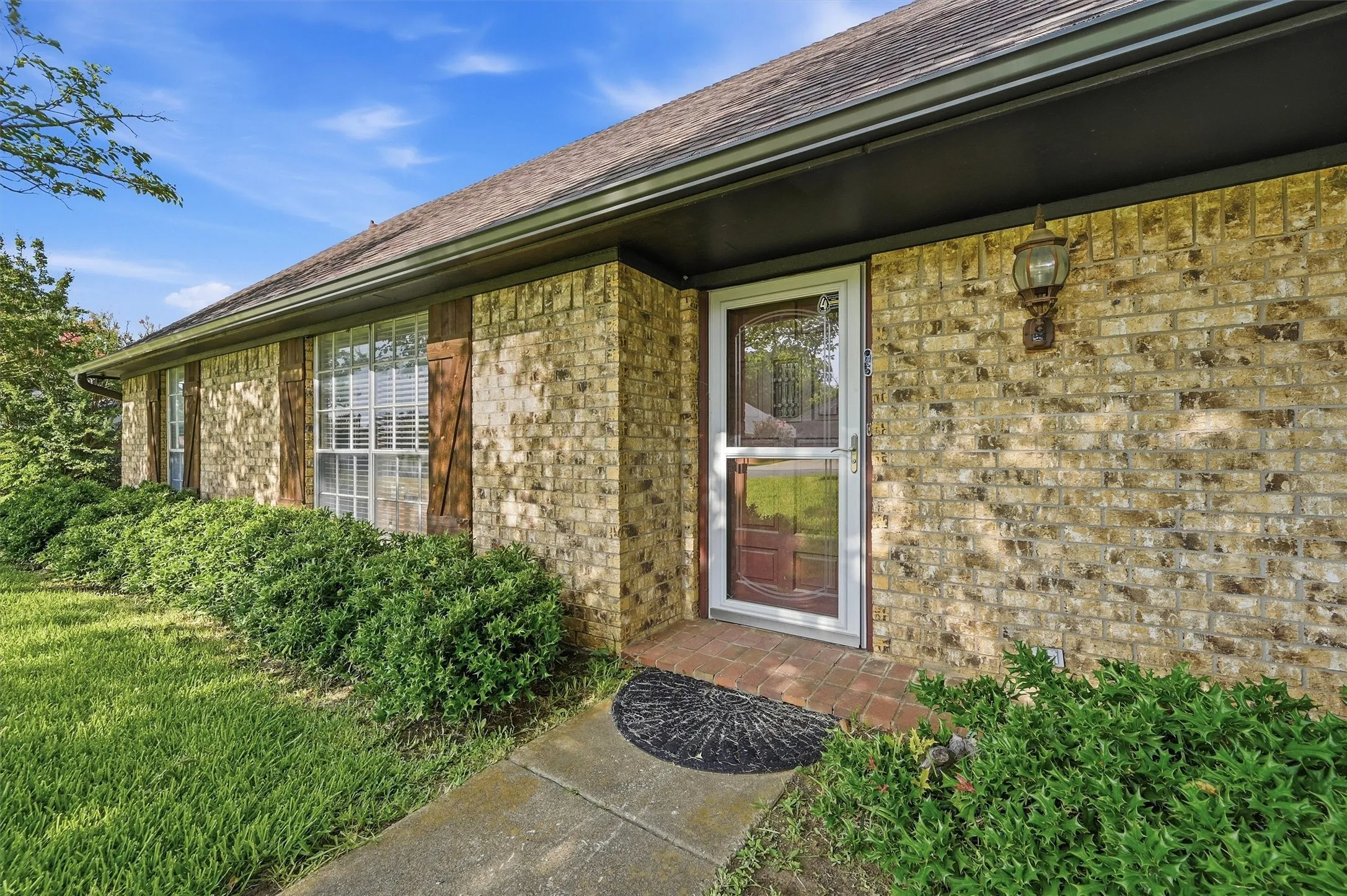 Brick exterior with a dark roof and black fascia