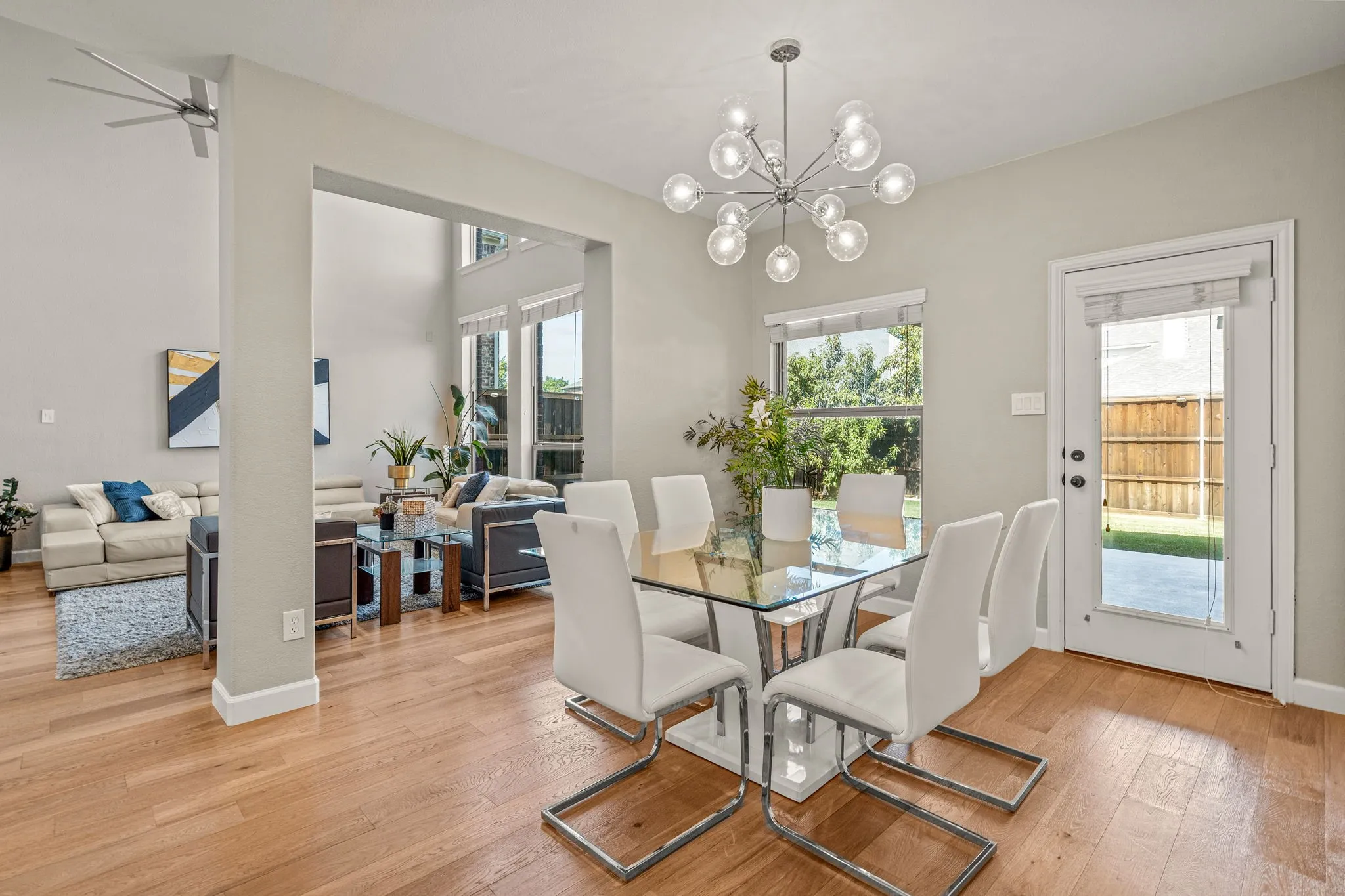 Dining area with light wood-type flooring, suspended lighting, and a ceiling fan