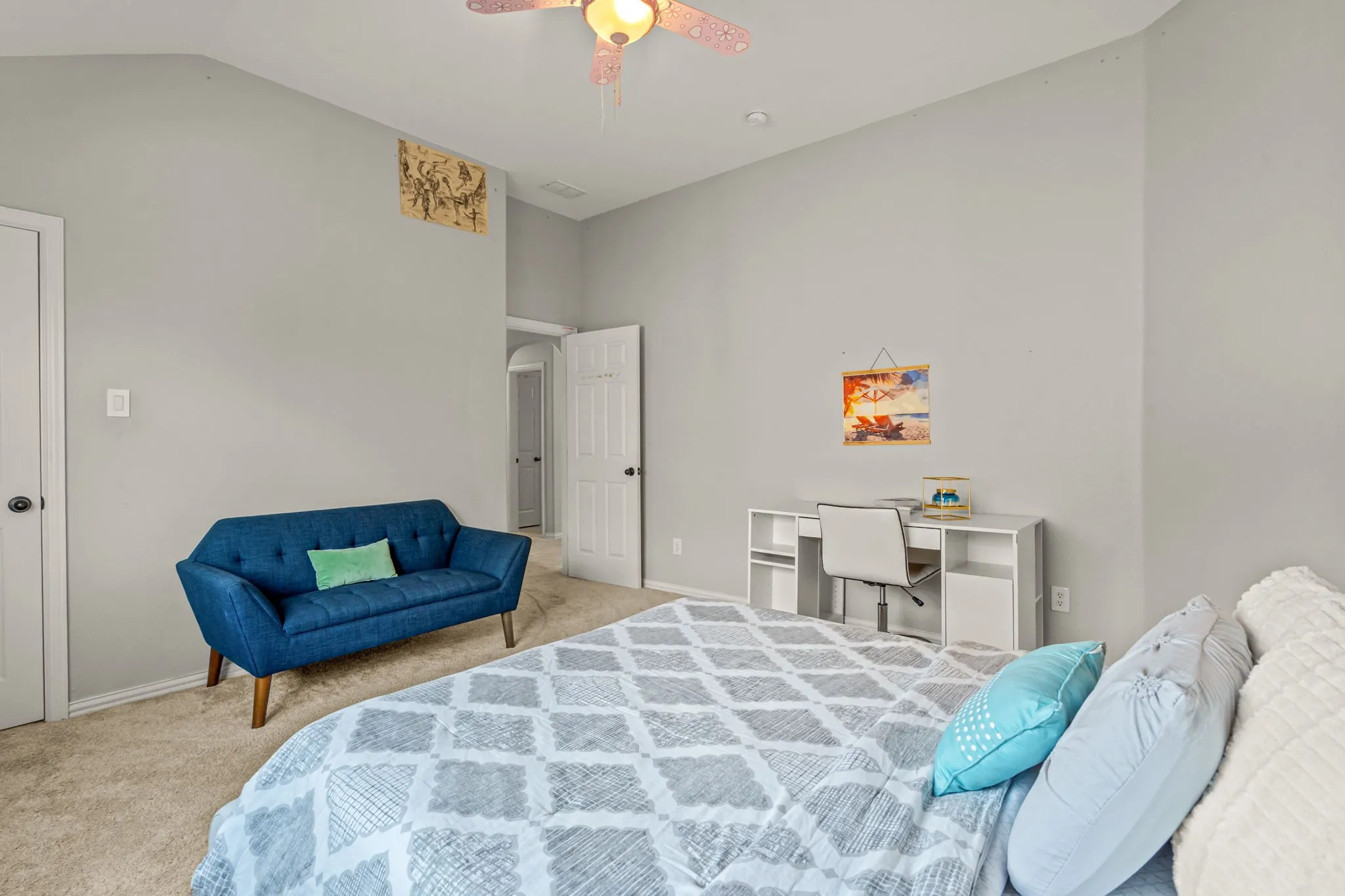 Bedroom featuring light carpet, lofted ceiling, and ceiling fan