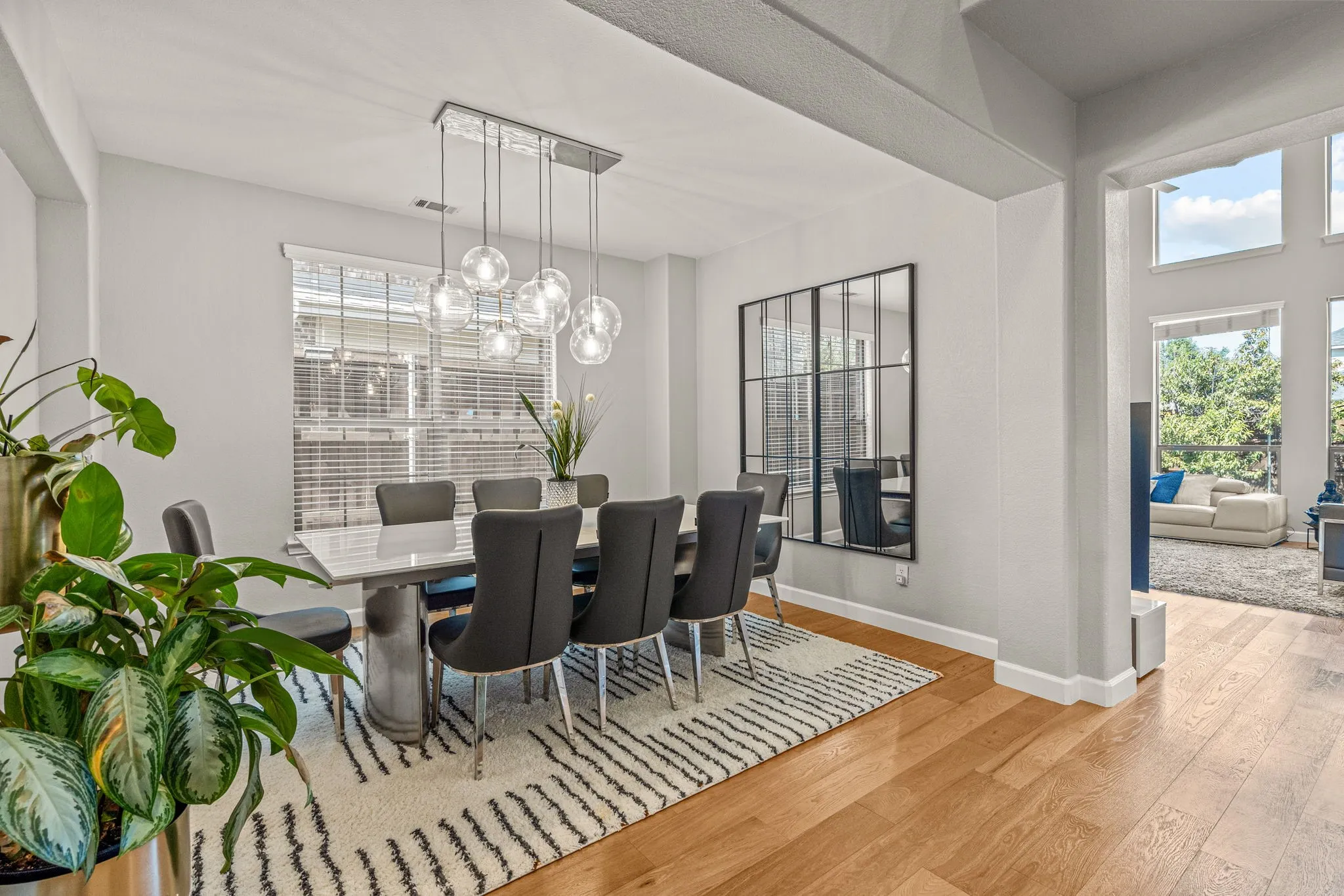 Dining room featuring light wood-style floors, healthy amount of natural light, and suspended lighting