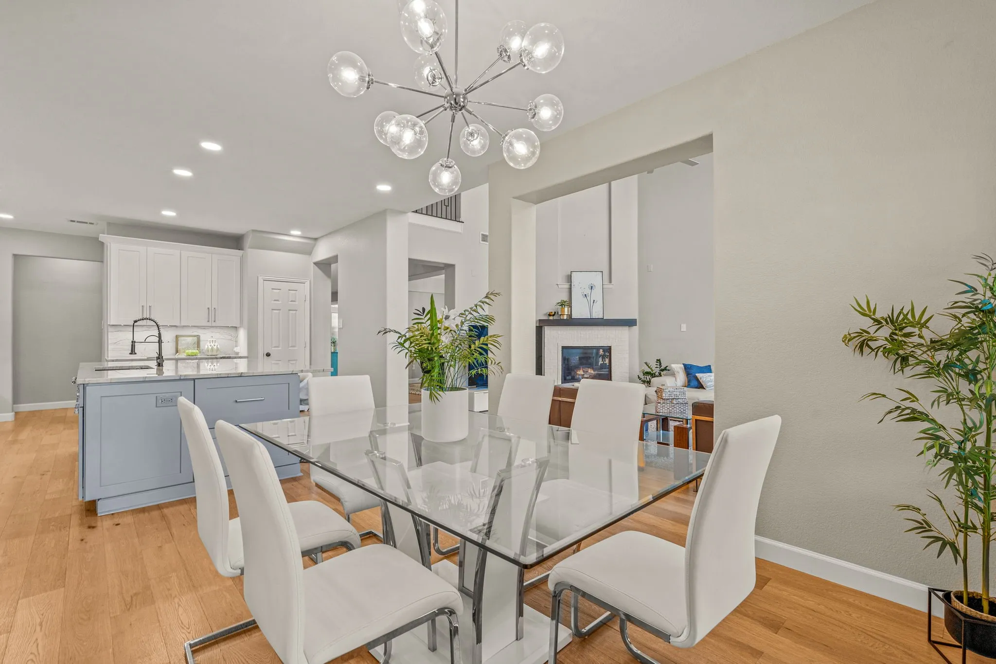 Dining room with light wood finished floors and a chandelier