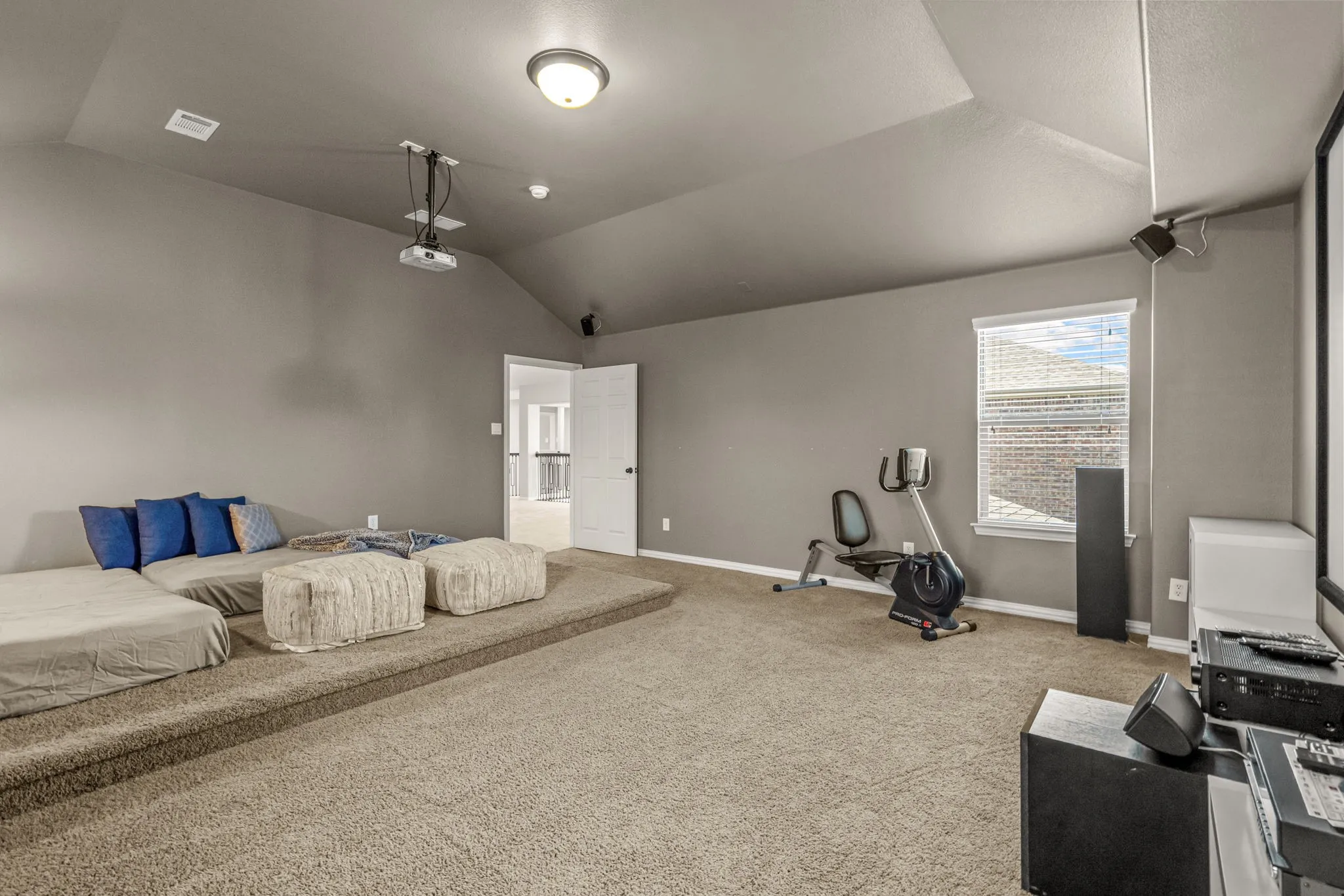 Bedroom featuring vaulted ceiling and light carpet