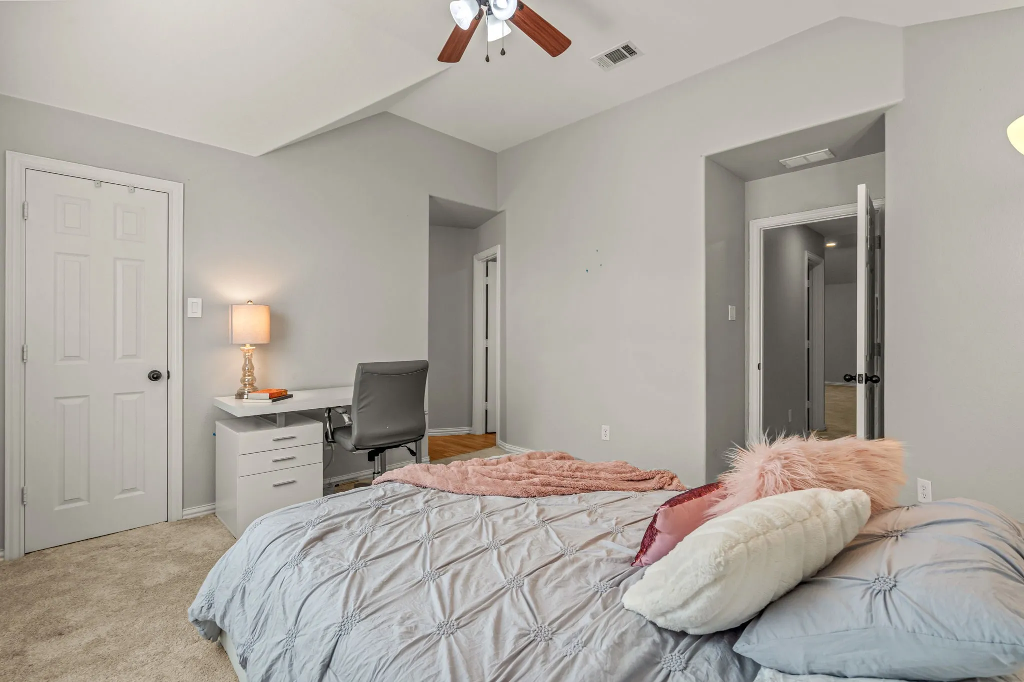 Bedroom featuring light carpet, an office area, ceiling fan, and vaulted ceiling