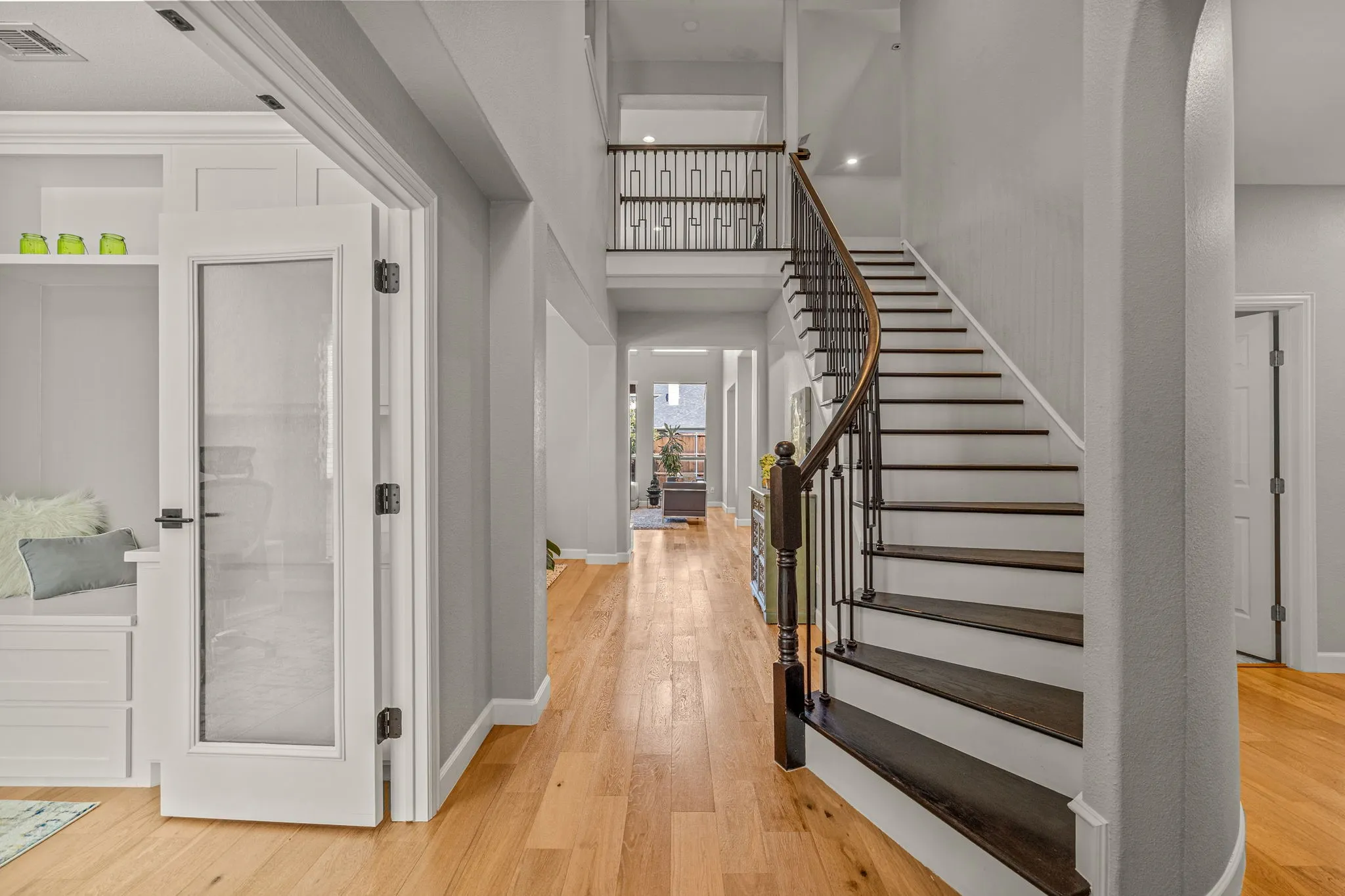 Entryway with light wood-style flooring and a high ceiling