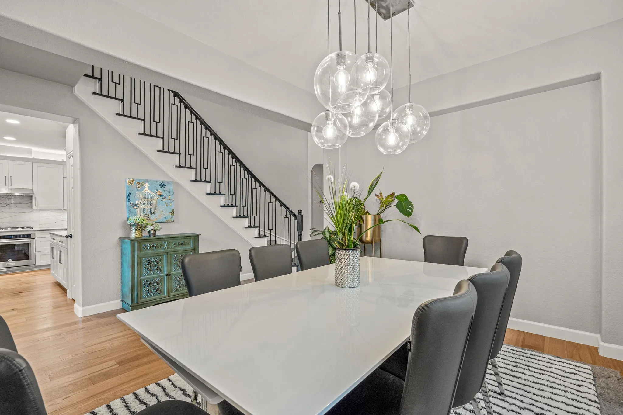 Dining space with arched walkways and light wood-style flooring