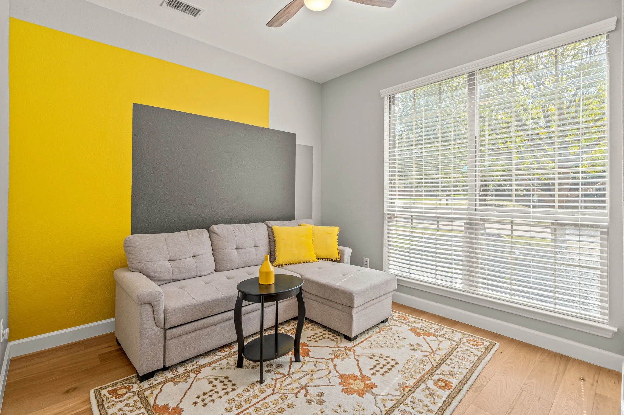 Ceiling fan and light wood finished floors