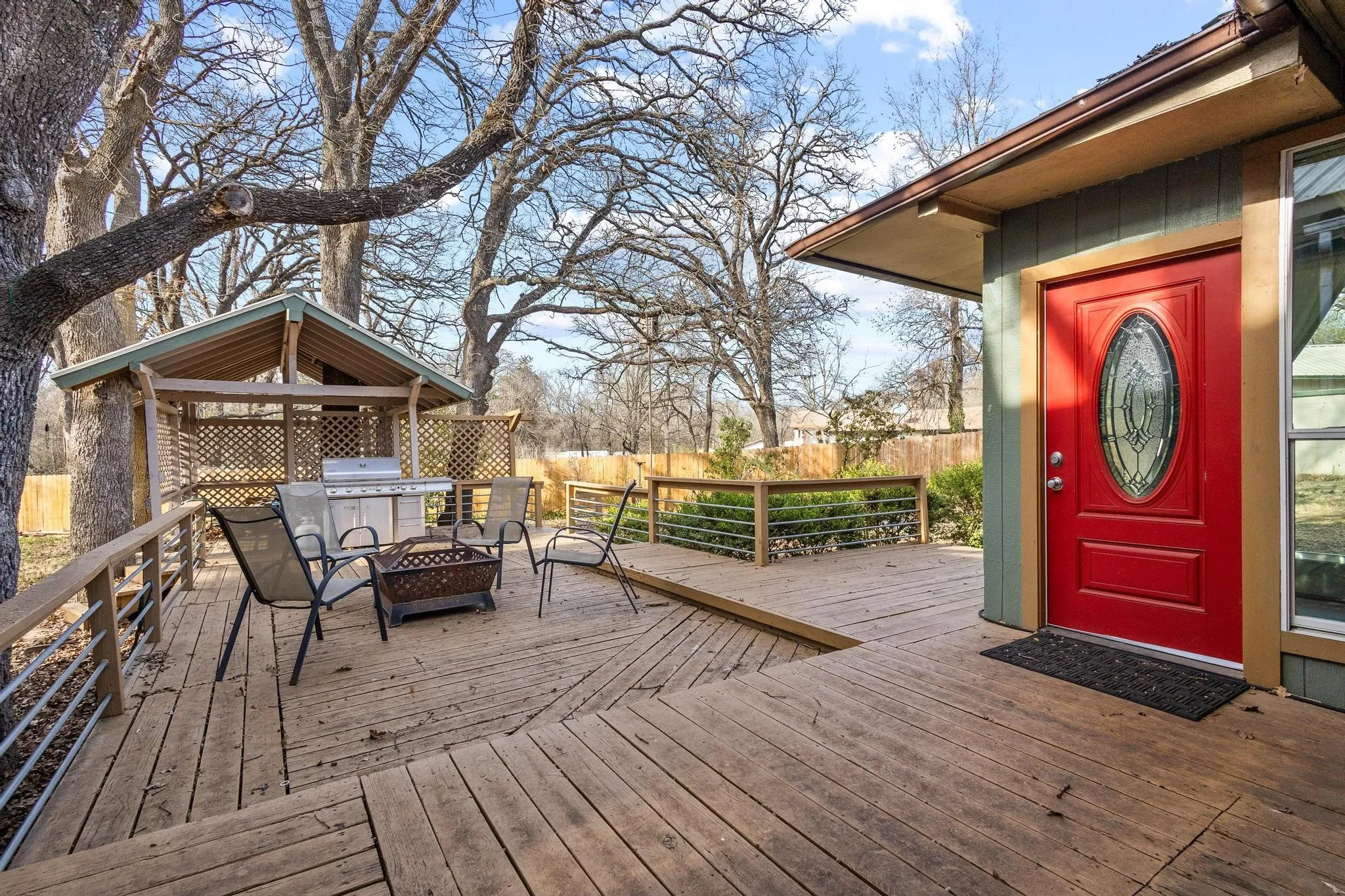 View of wooden terrace with fire pit