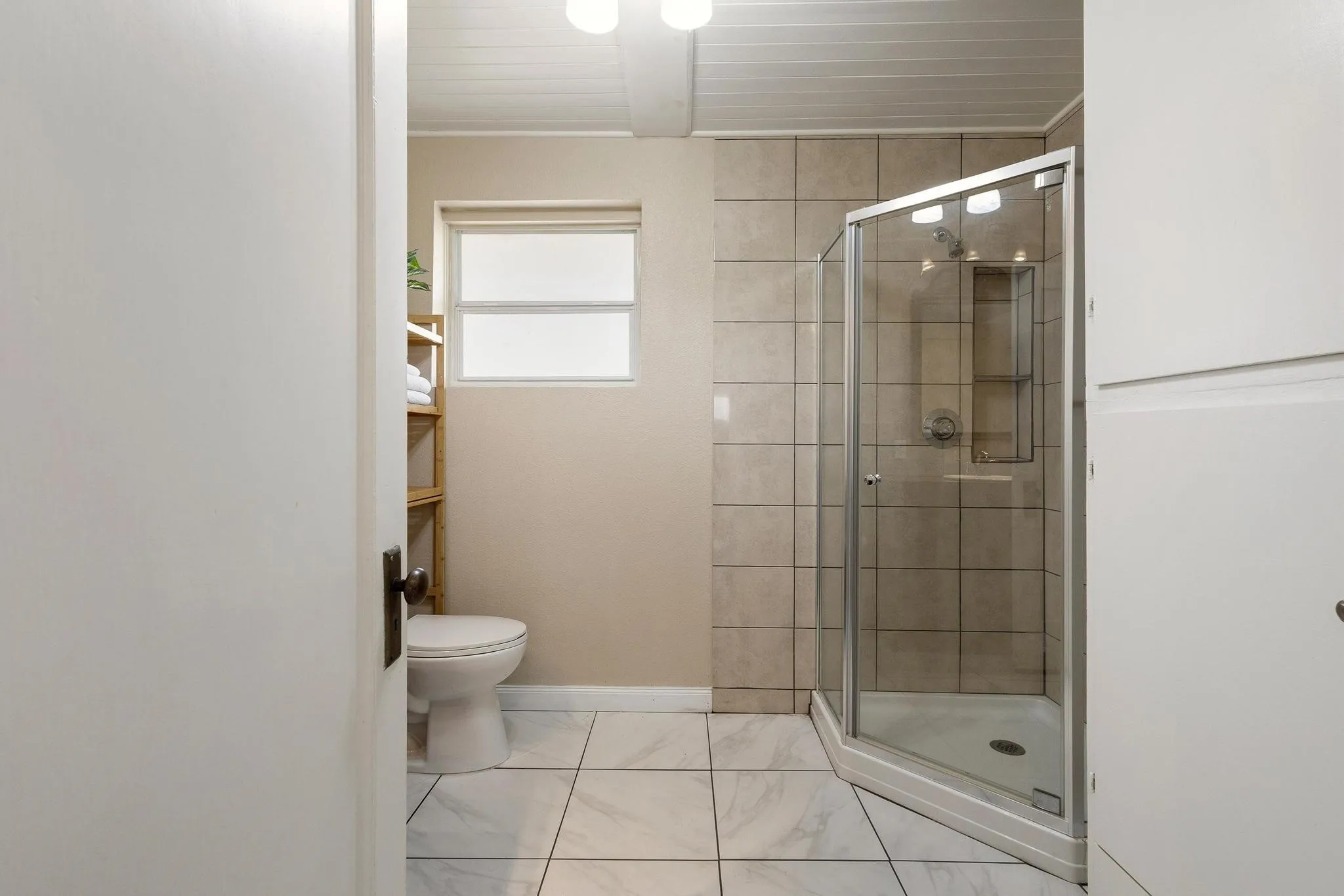 Shared bathroom with shower and built in storage