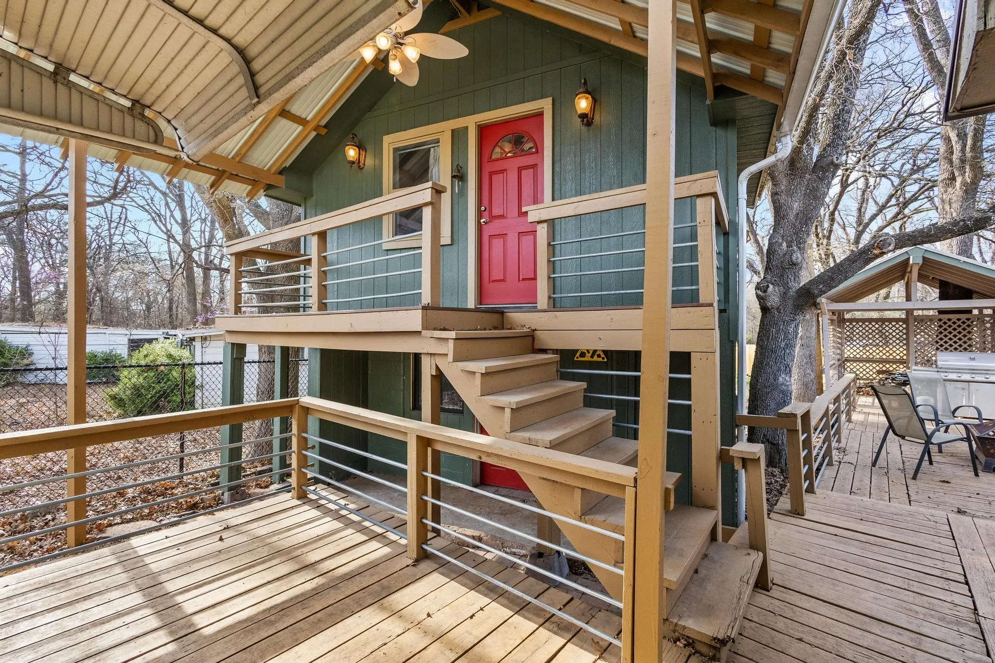 Deck featuring stairs and area for grilling