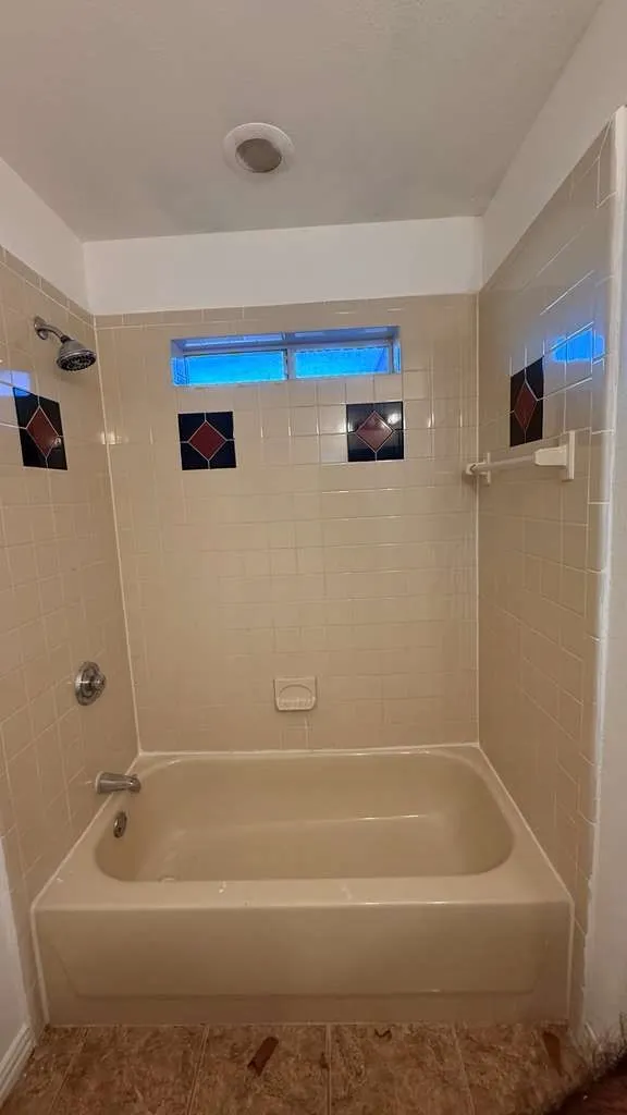 Bathroom with tub / shower combination and tile patterned floors